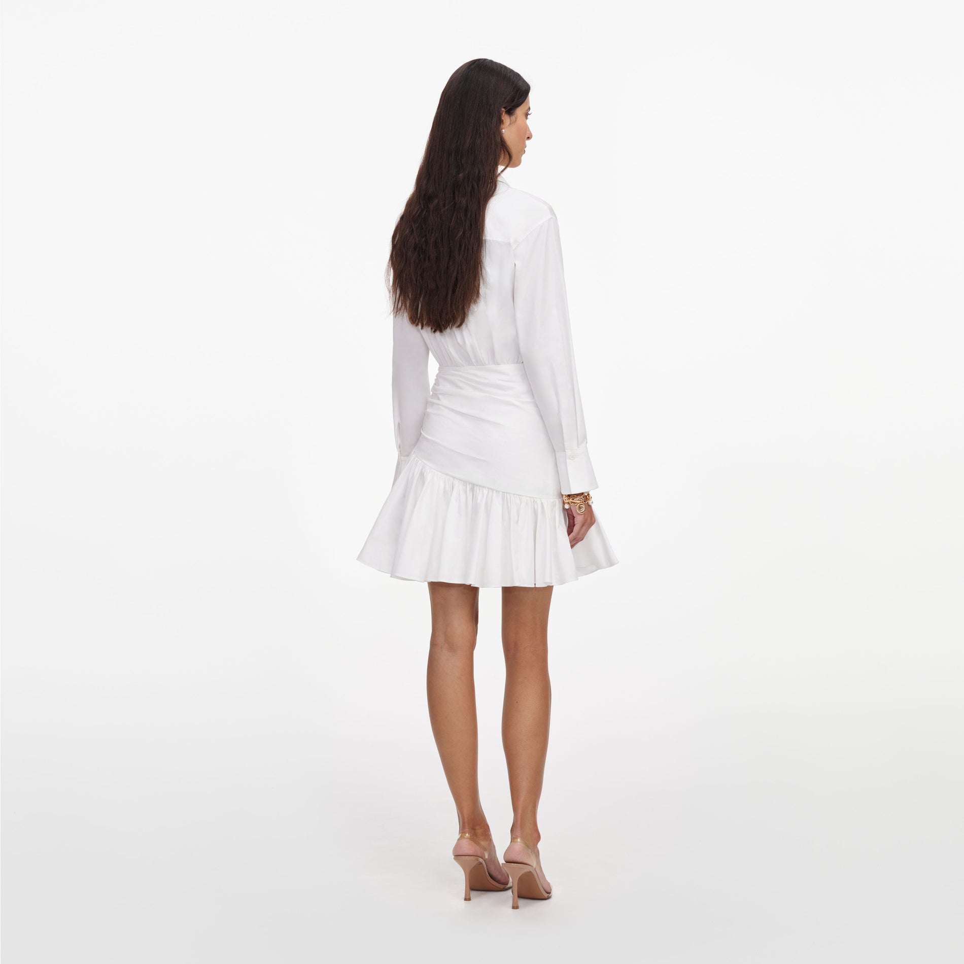 Back view of a woman wearing the White Cotton Gathered Mini Dress