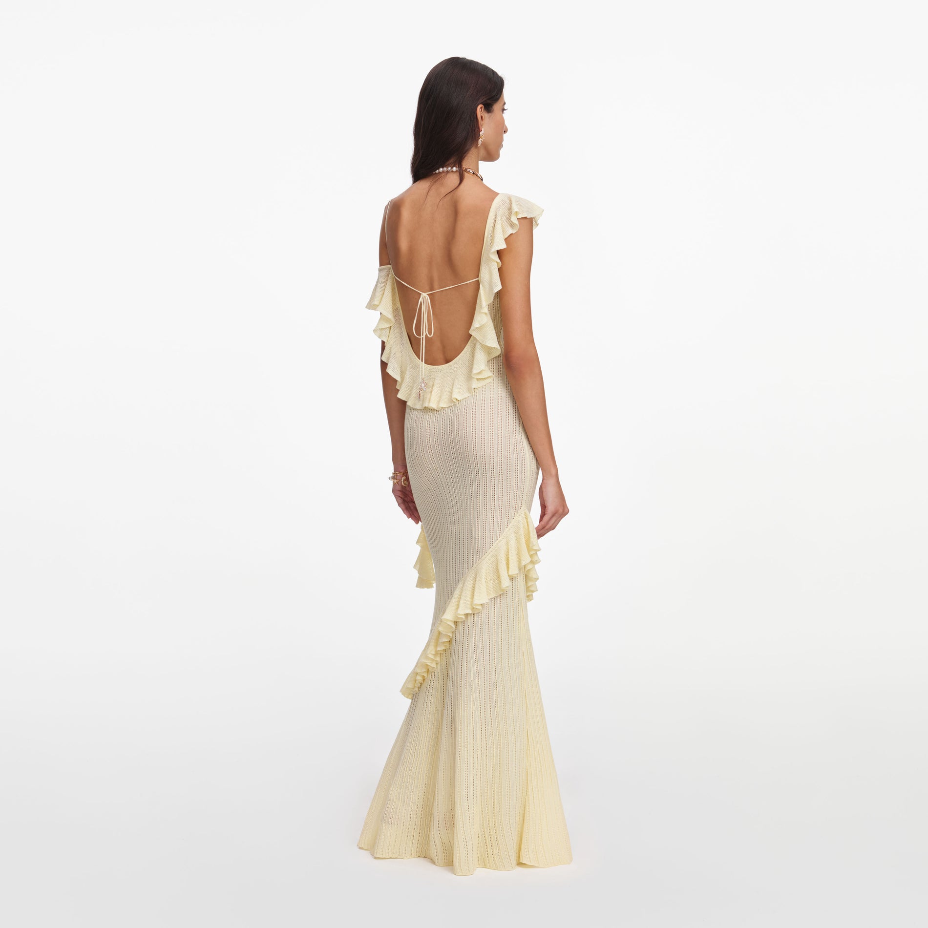 Back view of a woman wearing the Yellow Ruffle Knit Maxi Dress