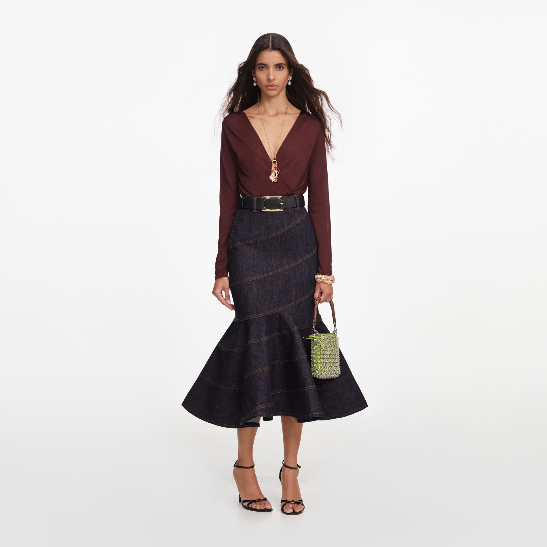 Front view of a woman wearing the Indigo Denim Belted Midi Skirt