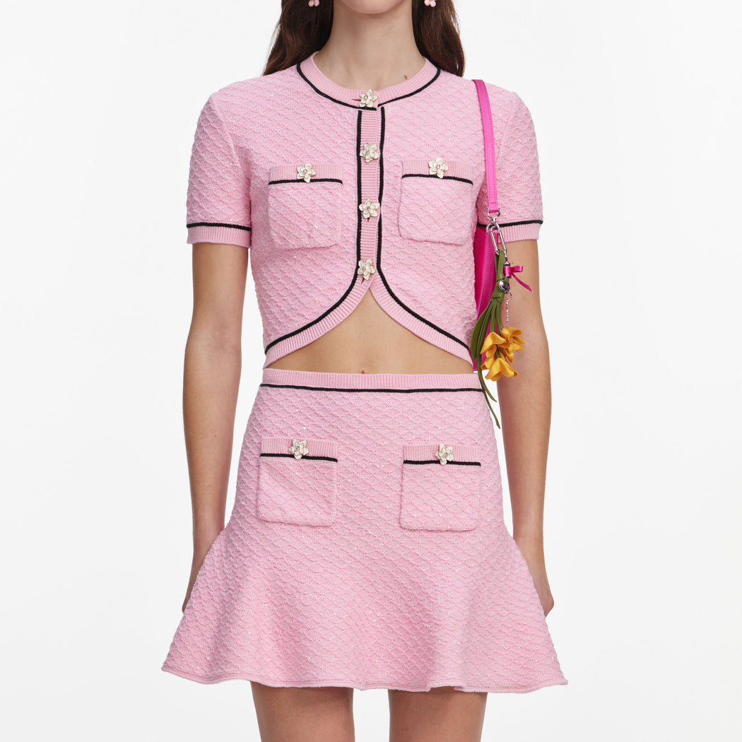 A close up of a woman wearing the Pink Flower Knit Mini Skirt