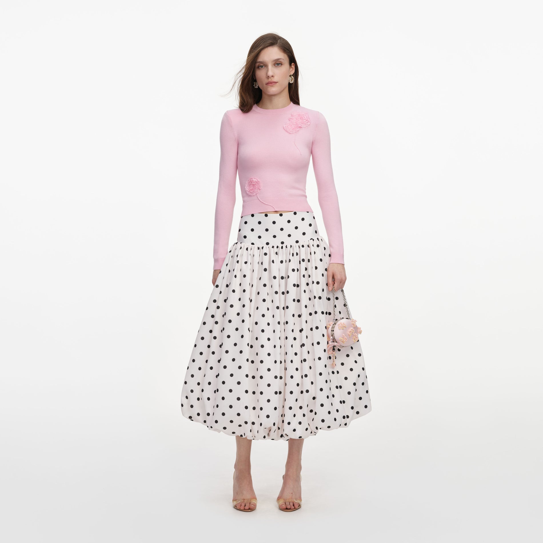 Front view of a woman wearing the Cream Polka Dot Taffeta Midi Skirt