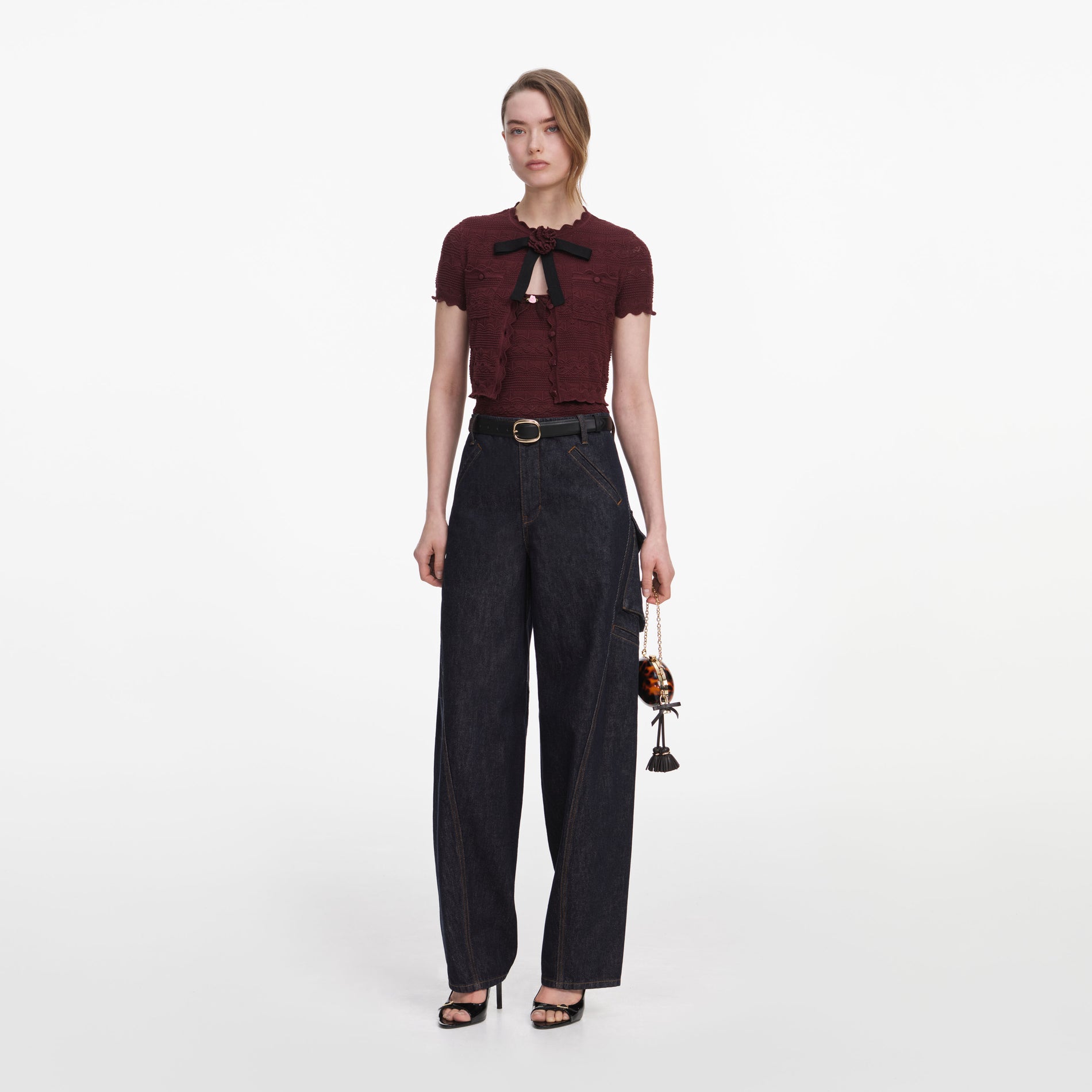 Side view of a woman wearing the Brown Pointelle Knit Top