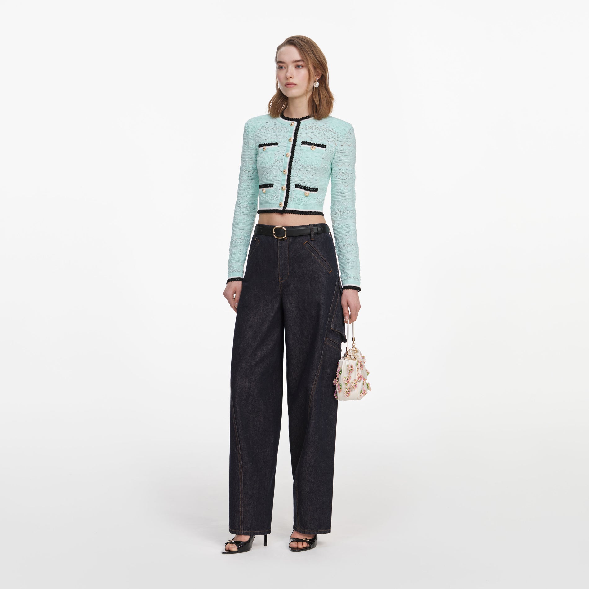 Side view of a woman wearing the Mint Pointelle Knit Cardigan