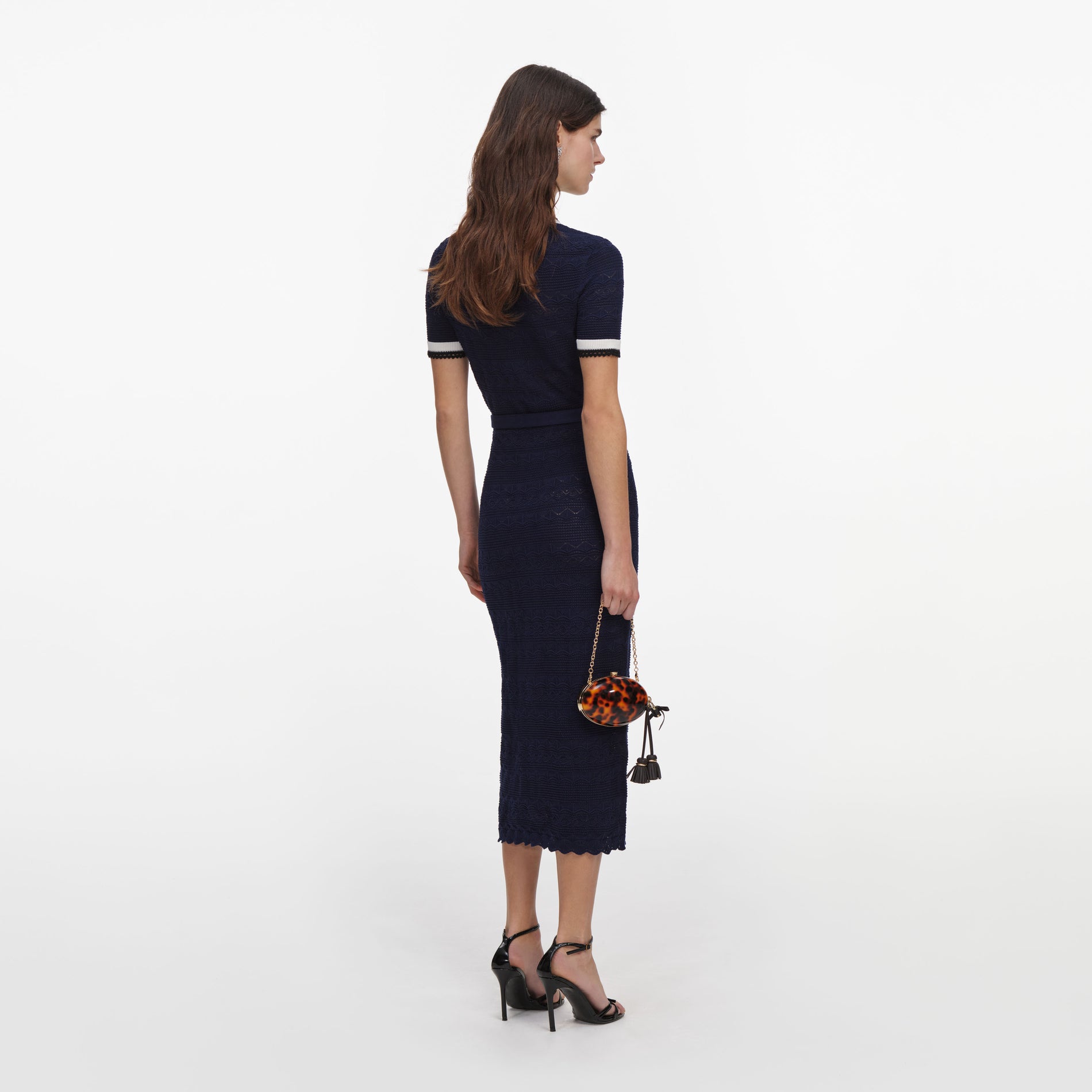 Back view of a woman wearing the Navy Pointelle Knit Midi Dress