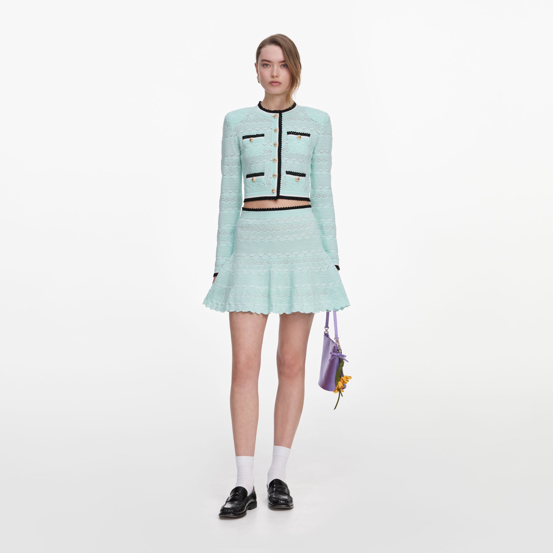 Front view of a woman wearing the Mint Pointelle Knit Mini Skirt