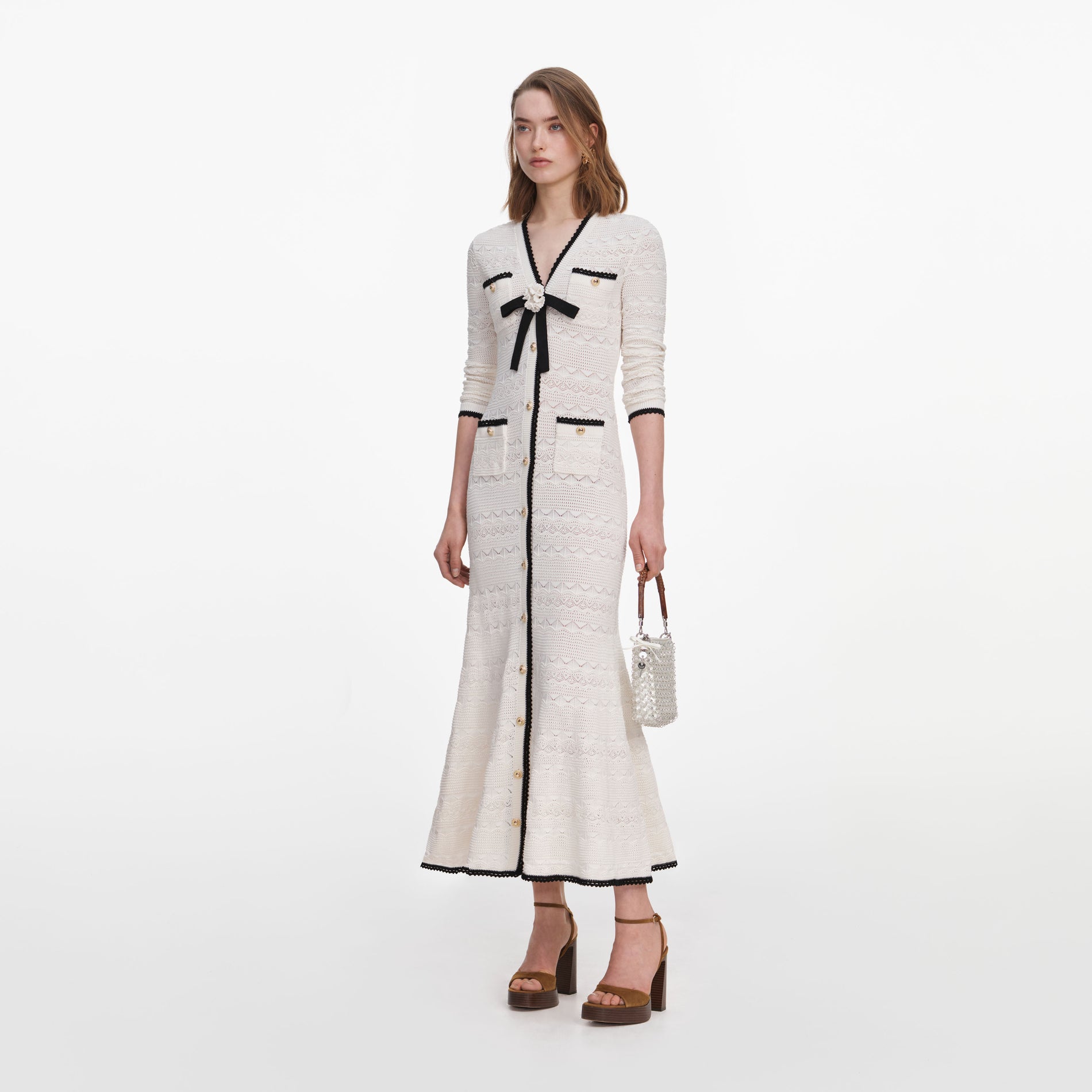 Side view of a woman wearing the White Pointelle Knit Long Cardigan