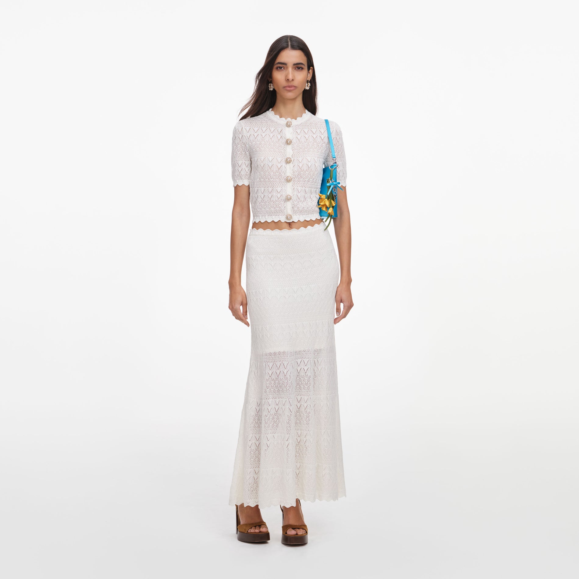 Front view of a woman wearing the White Pointelle Knit Midi Skirt