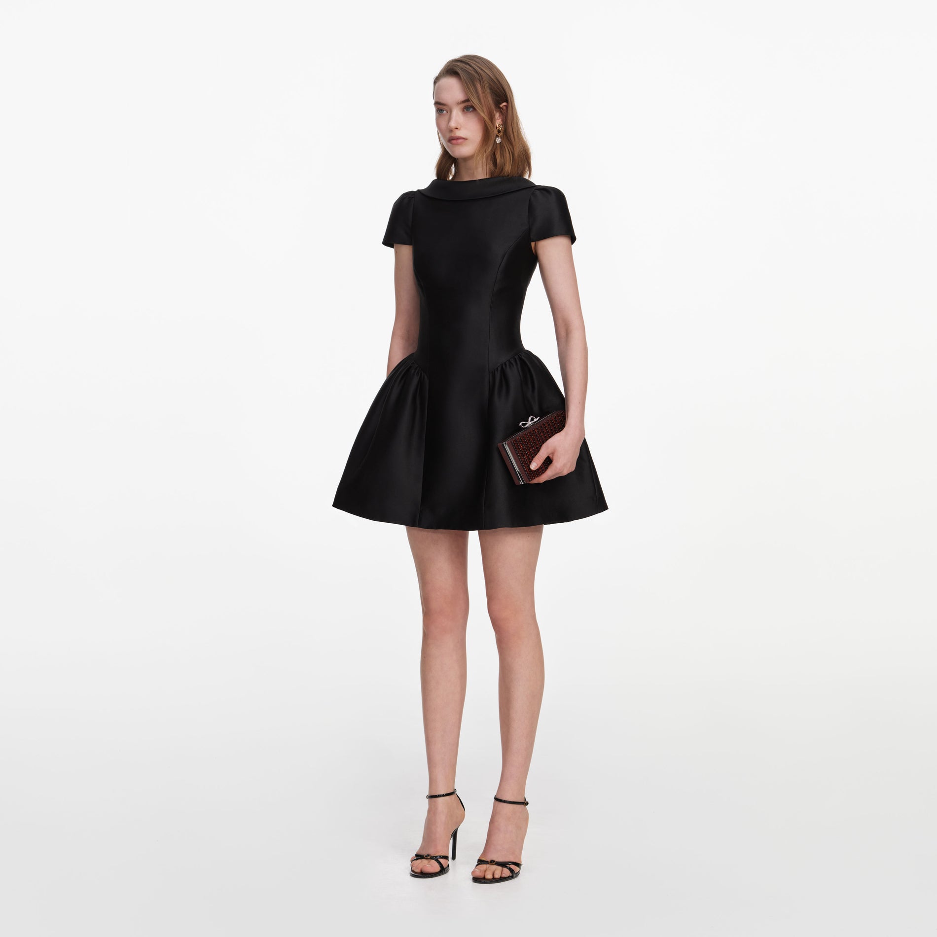 Side view of a woman wearing the Black Taffeta Collared Mini Dress