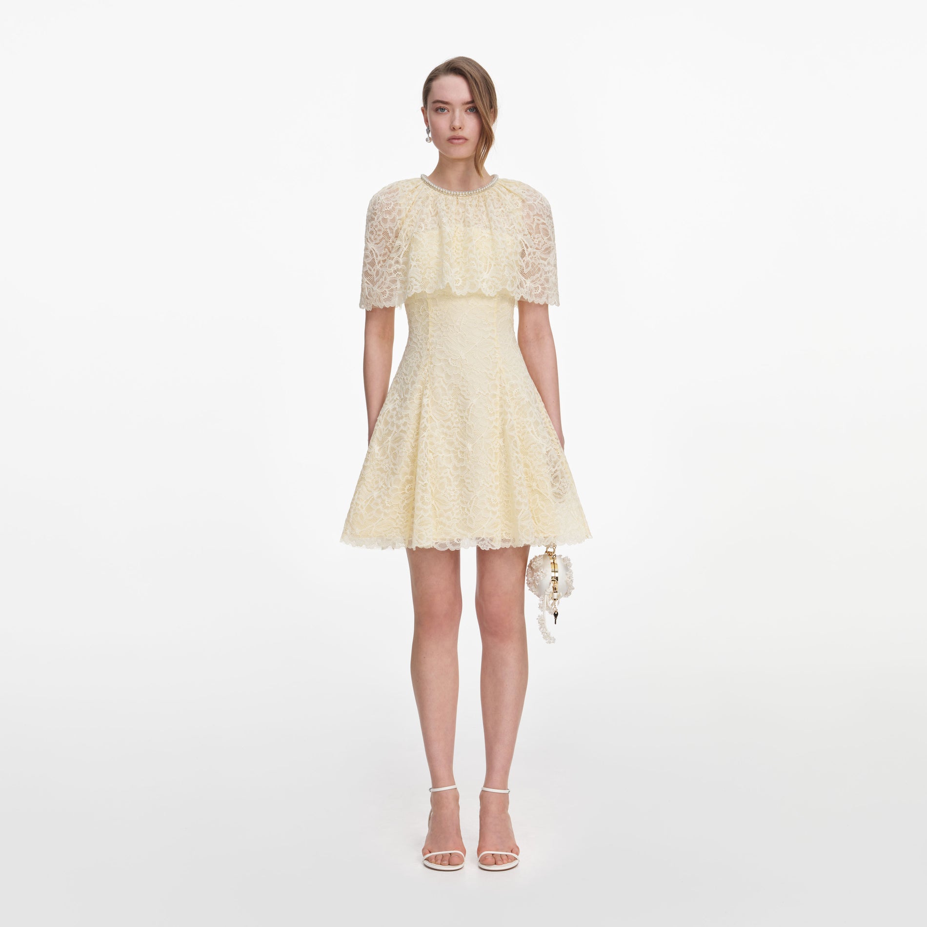 Front view of a woman wearing the Yellow Lace Cape Mini Dress