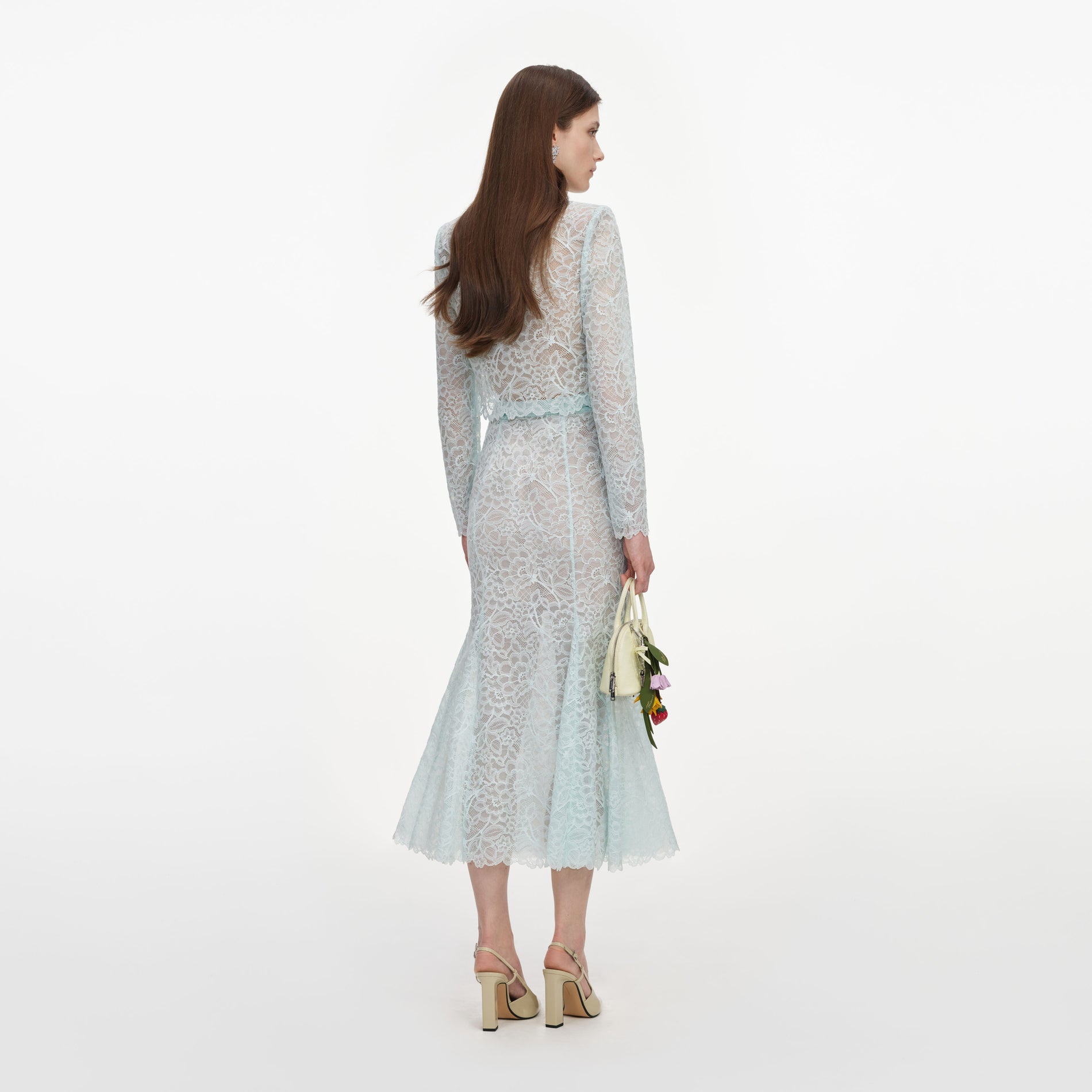 Back view of a woman wearing the Mint Lace Midi Skirt