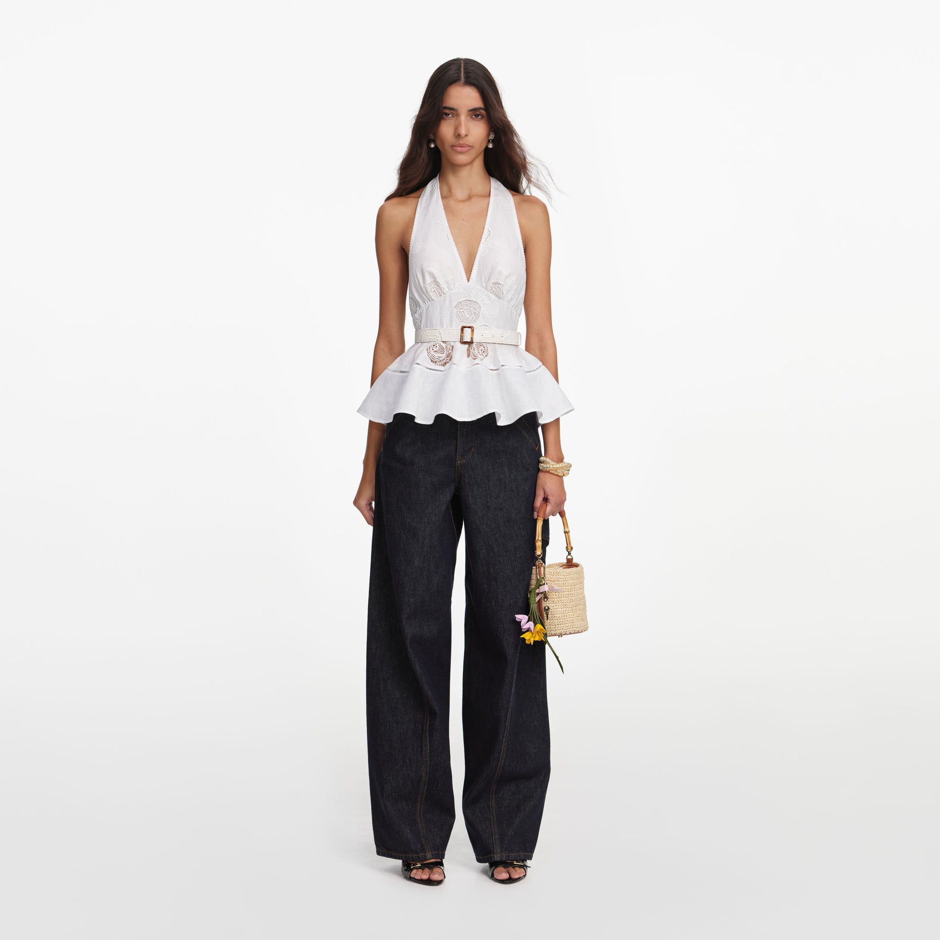 Front view of a woman wearing the White Linen Blend Peplum Top