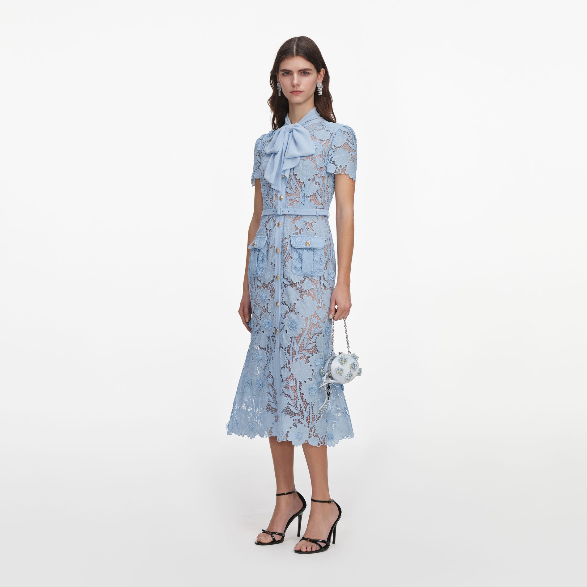 Side view of a woman wearing the Blue Lace Tie Neck Midi Dress