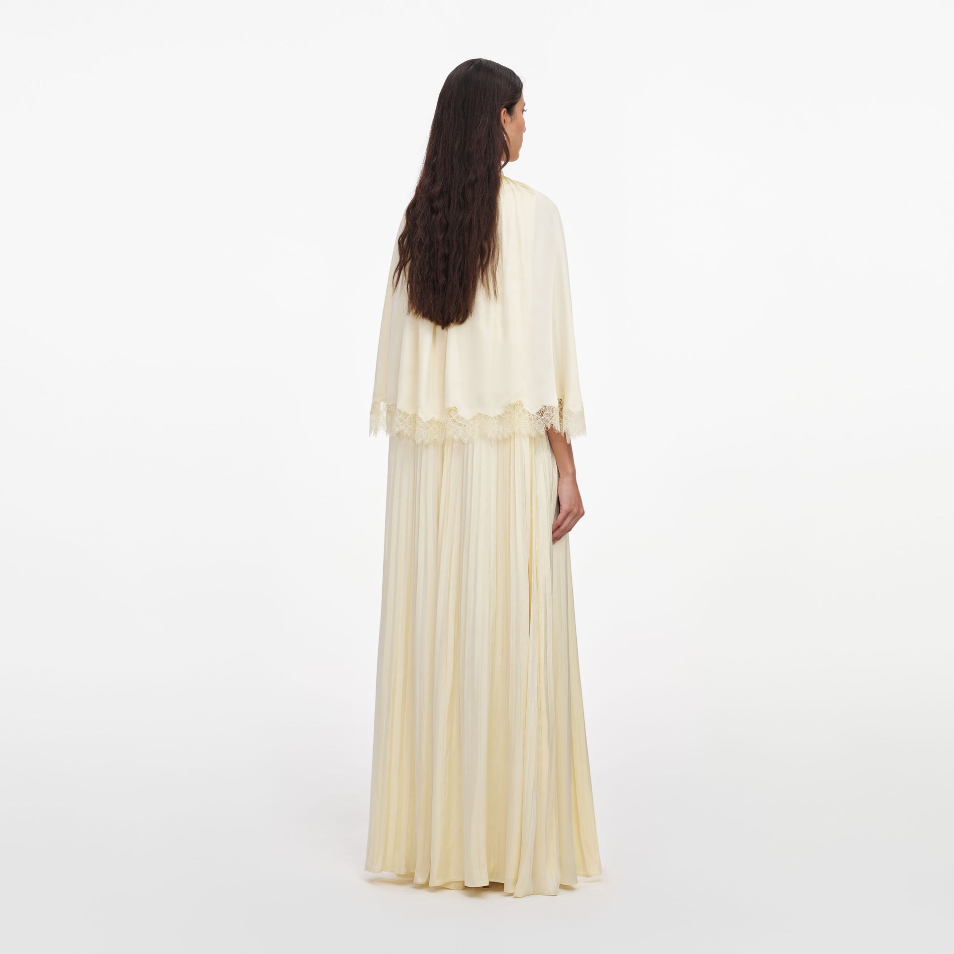 Back view of a woman wearing the Yellow Tie Neck Cape Maxi Dress