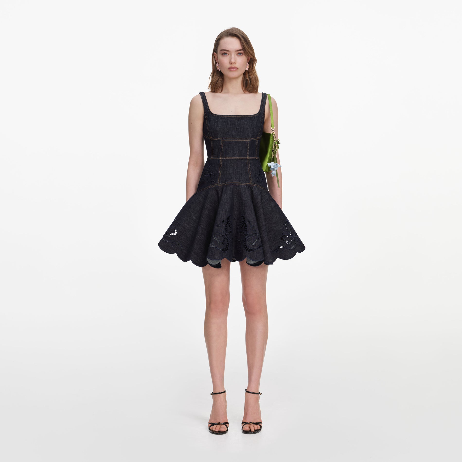 Front view of a woman wearing the Indigo Denim Bow Embroidered Mini Dress