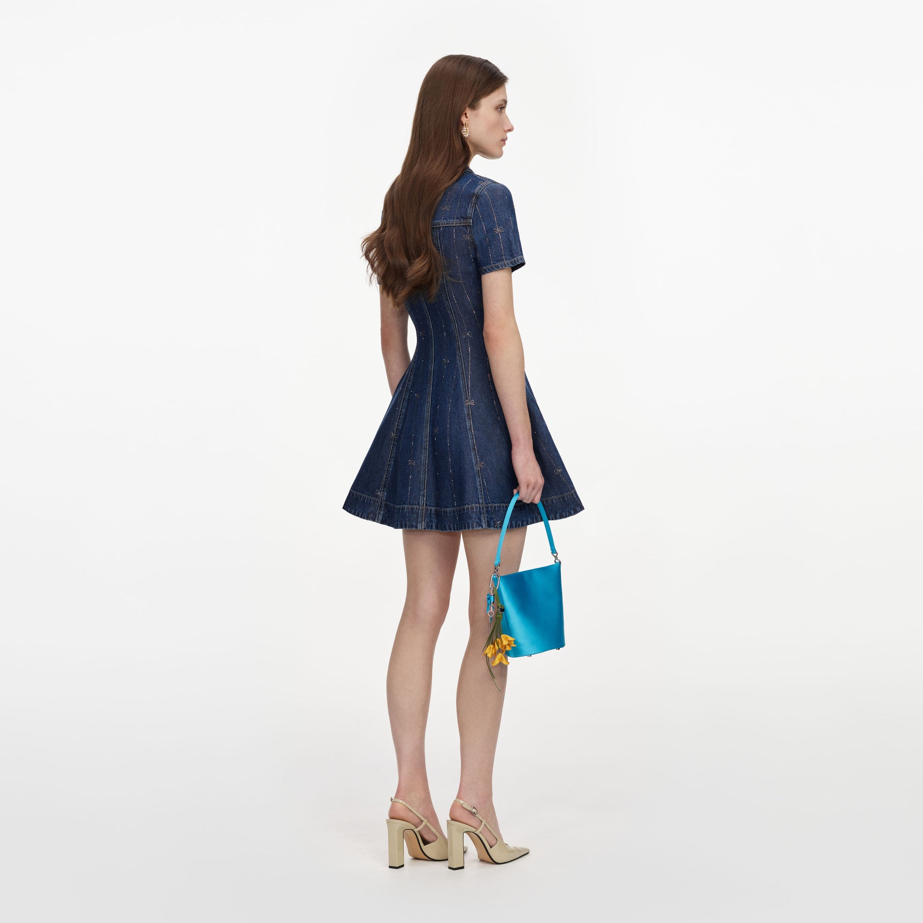 Back view of a woman wearing the Rhinestone Stripe Denim Mini Dress