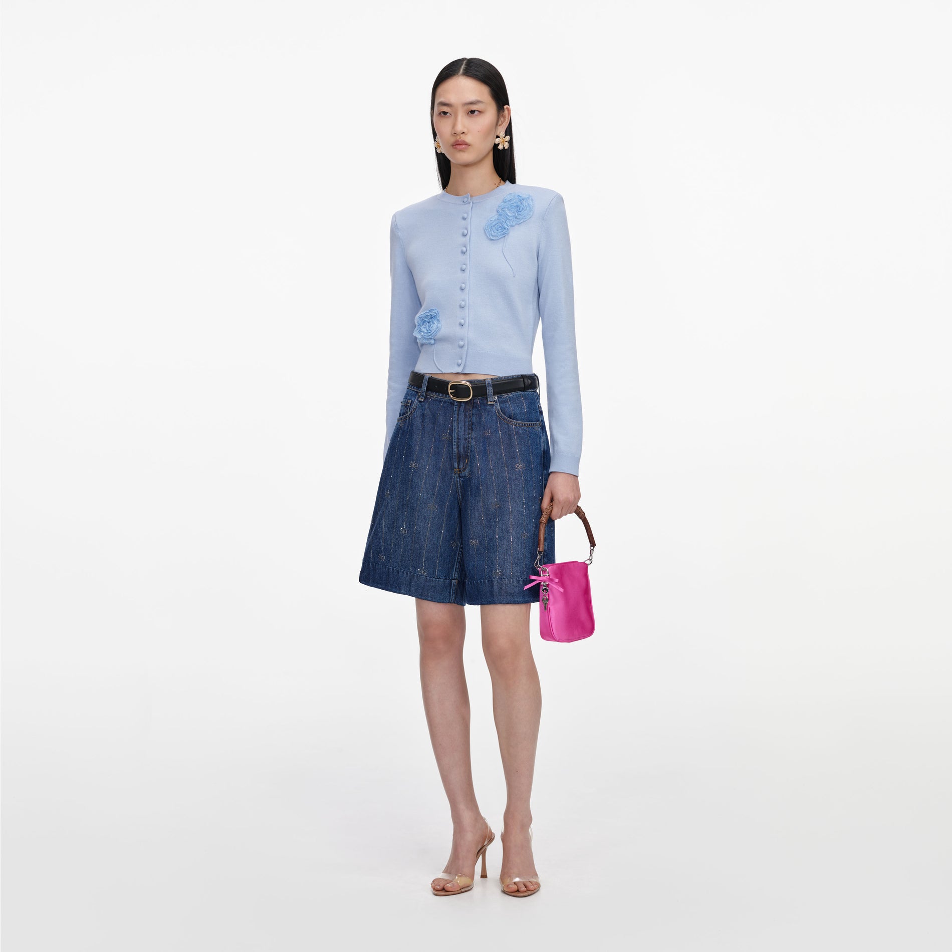 Side view of a woman wearing the Rhinestone Stripe Denim Shorts