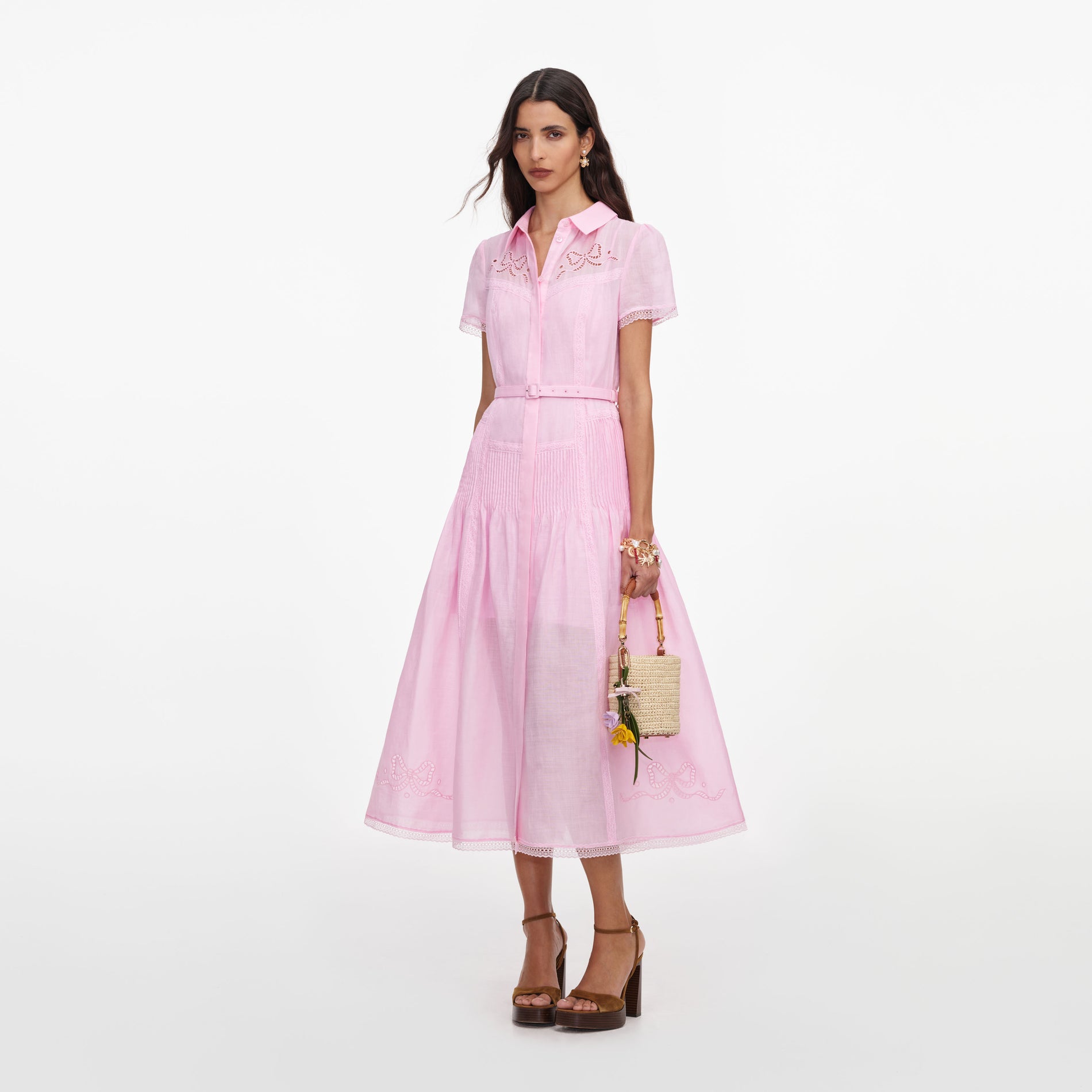 Side view of a woman wearing the Pink Embroidered Midi Dress