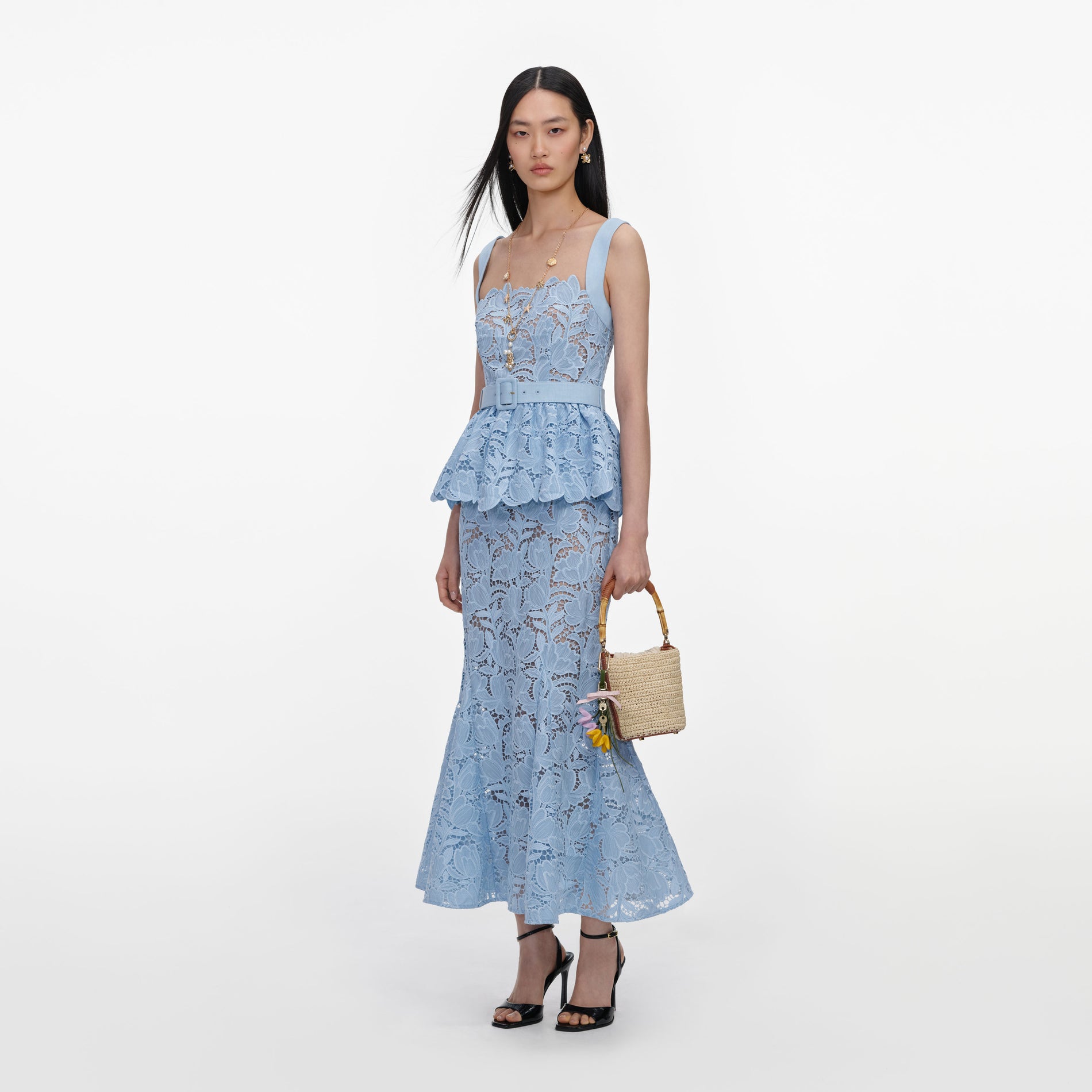 Side view of a woman wearing the Blue Lace Peplum Midi Dress