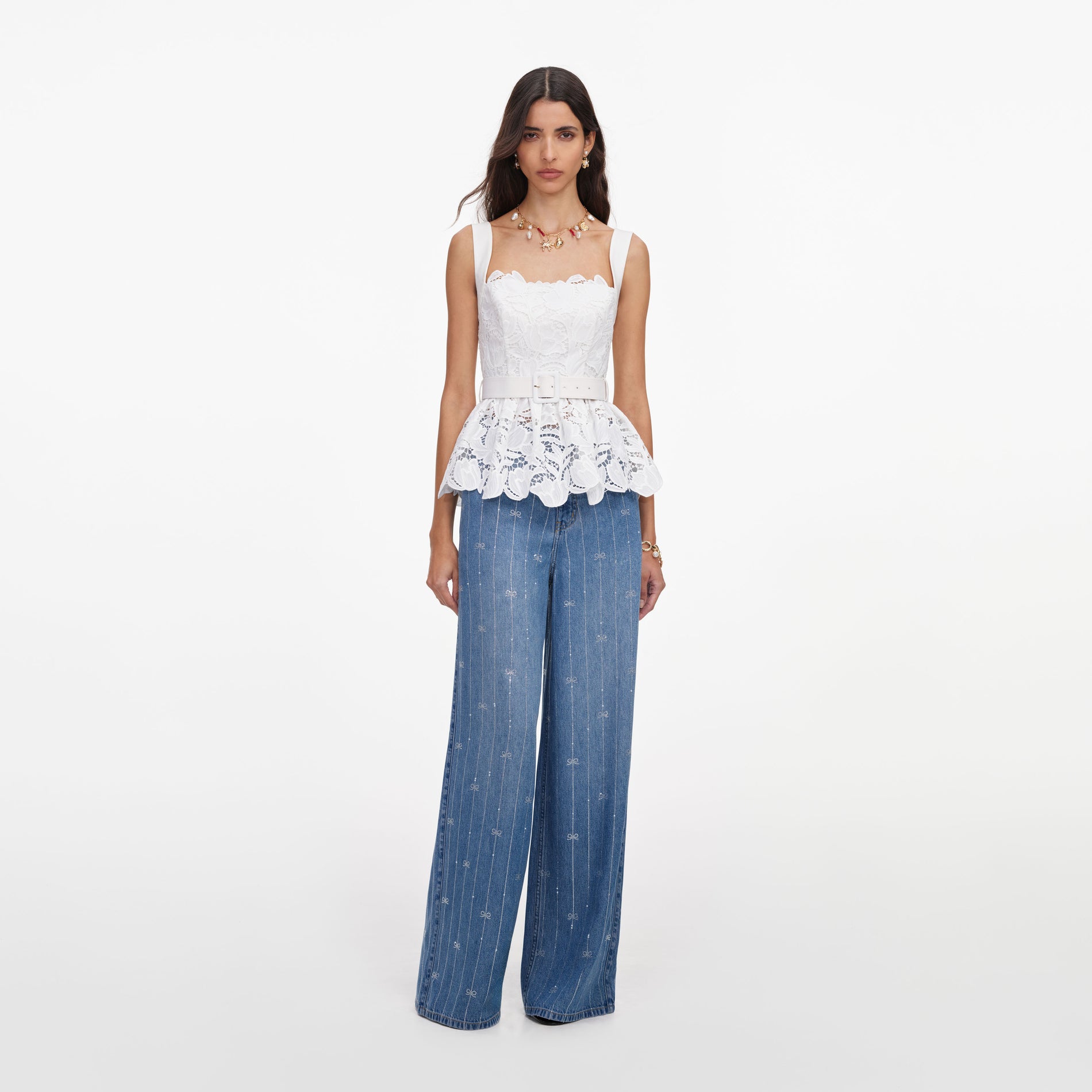 Front view of a woman wearing the White Lace Peplum Top