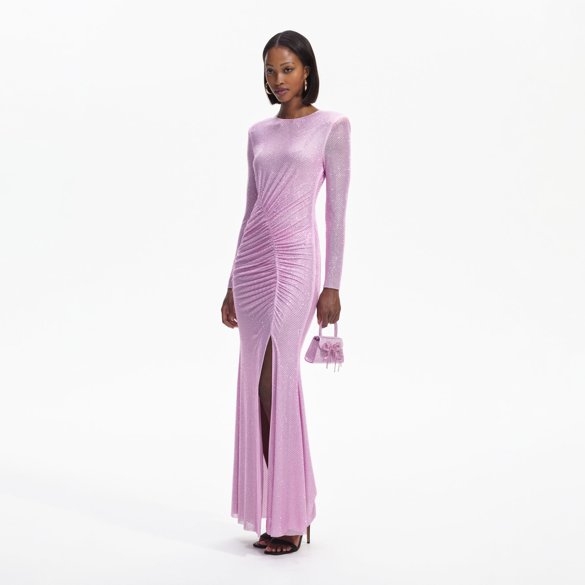 Side view of a woman wearing the Pink Rhinestone Mesh Maxi Dress