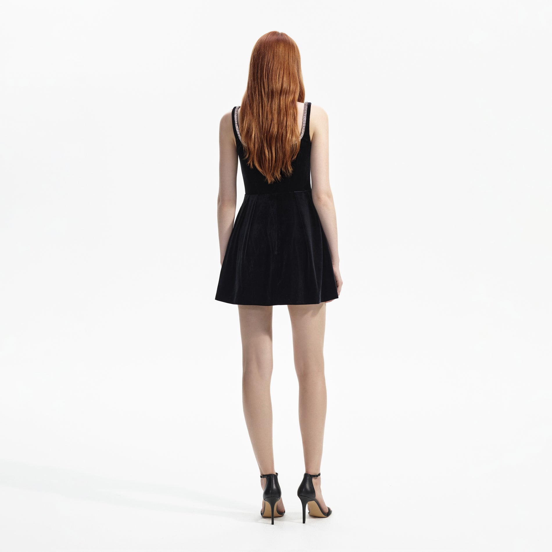 Back view of a woman wearing the Black Velvet Skater Mini Dress