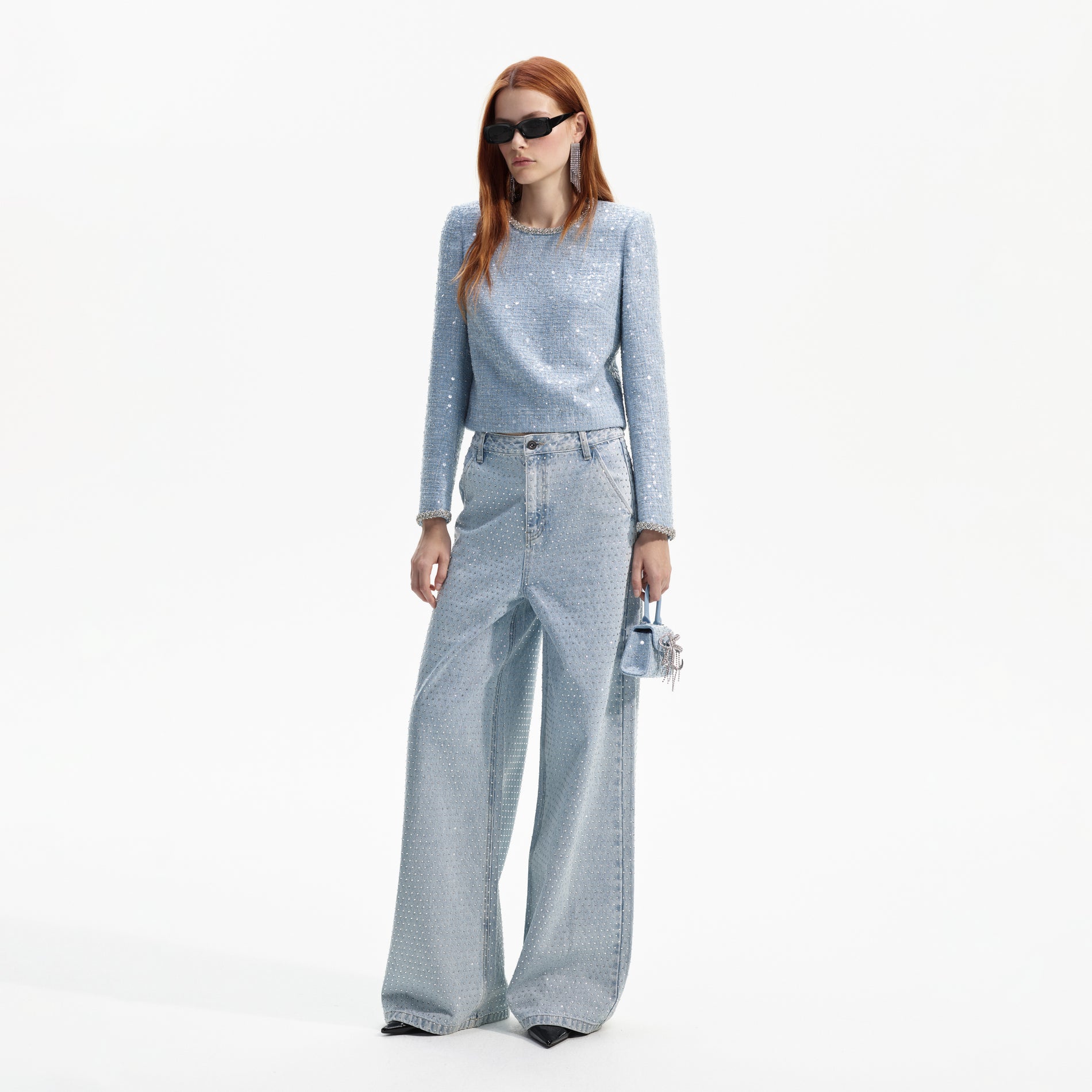 Side view of a woman wearing the Blue Sequin Boucle Top