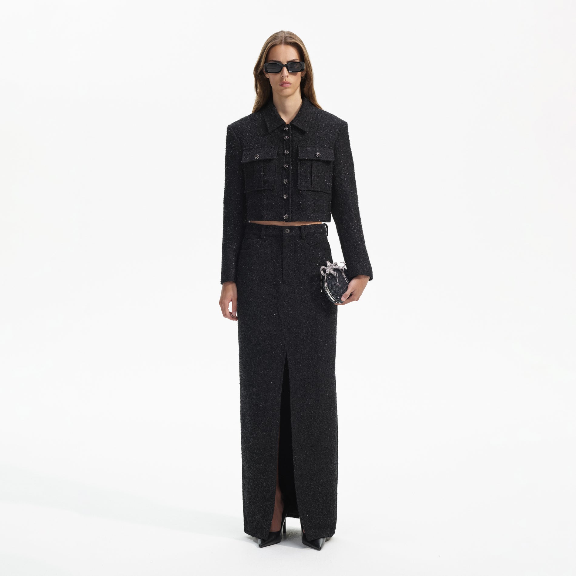 Front view of a woman wearing the Black Boucle Maxi Skirt