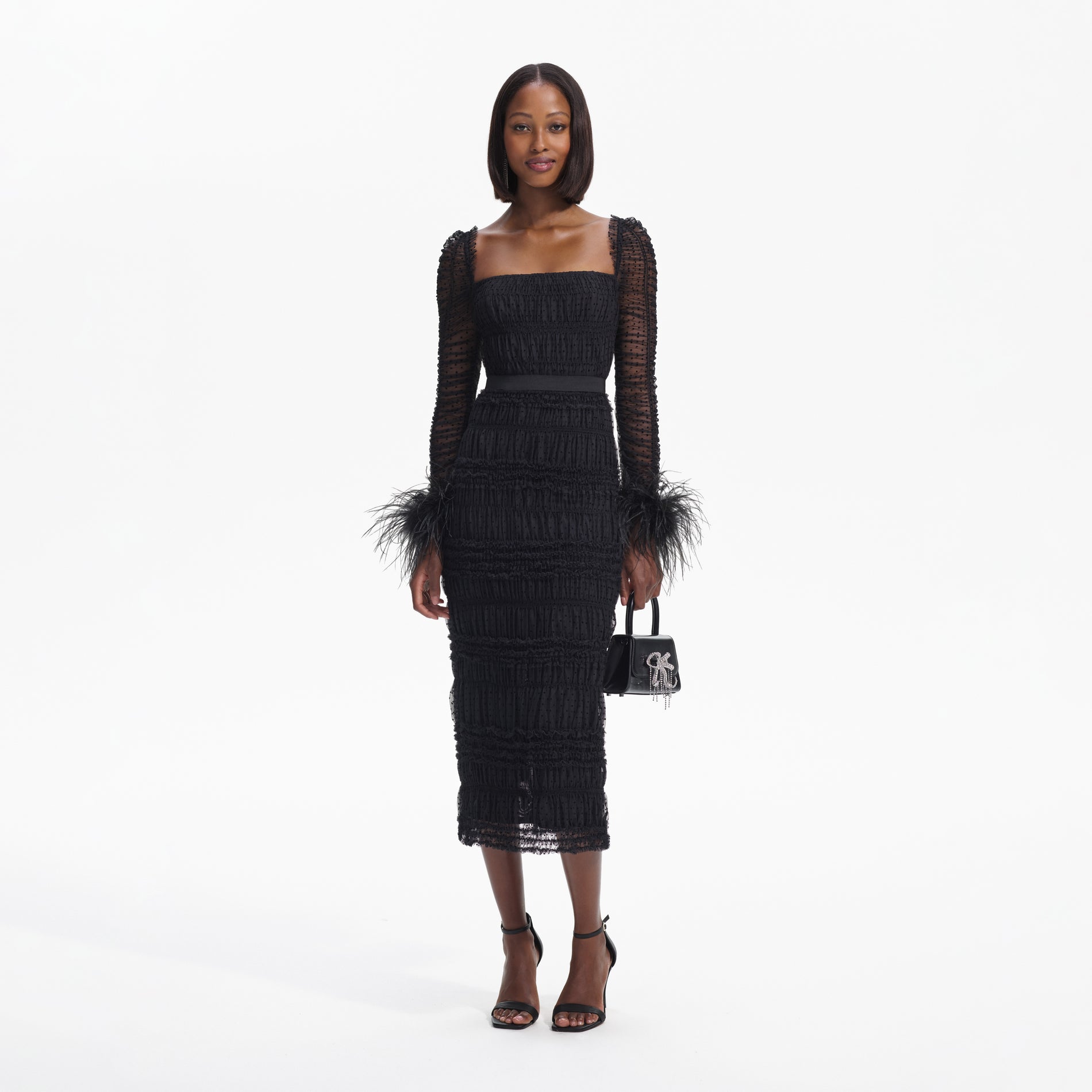 Front view of a woman wearing the Black Dot Mesh Feather Midi Dress