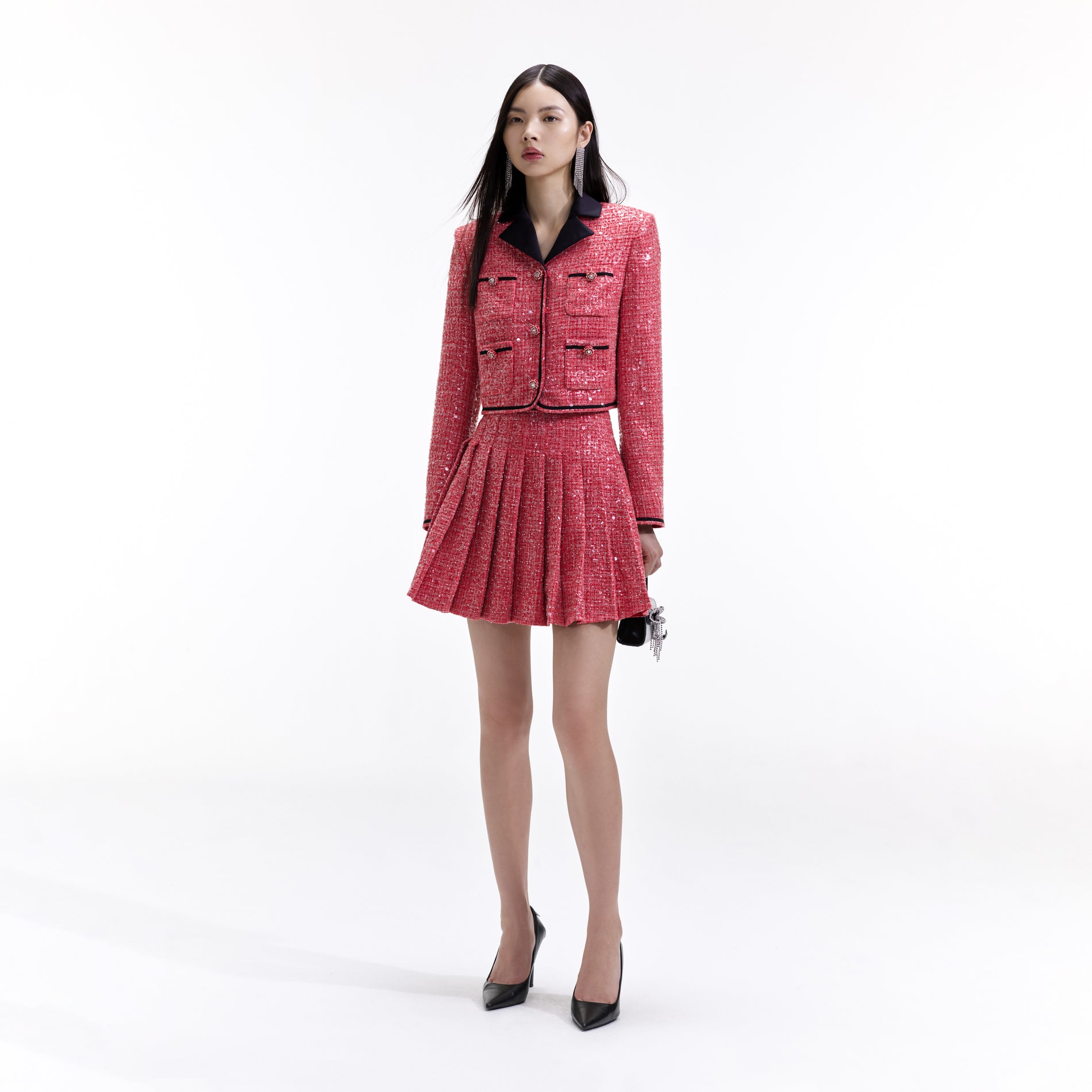 Side view of a woman wearing the Red Boucle Mini Skirt