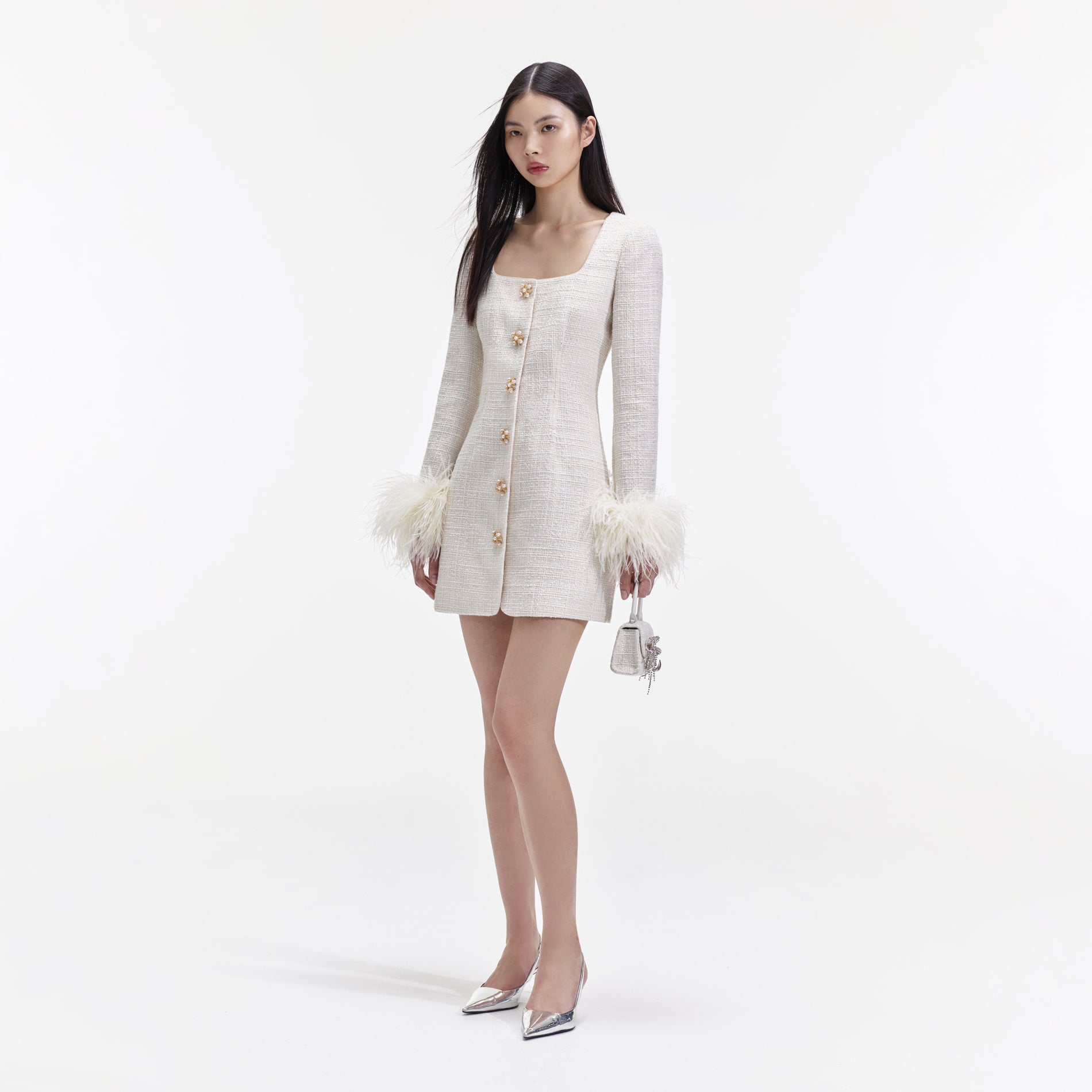 Side view of a woman wearing the Cream Boucle Feather Mini Dress