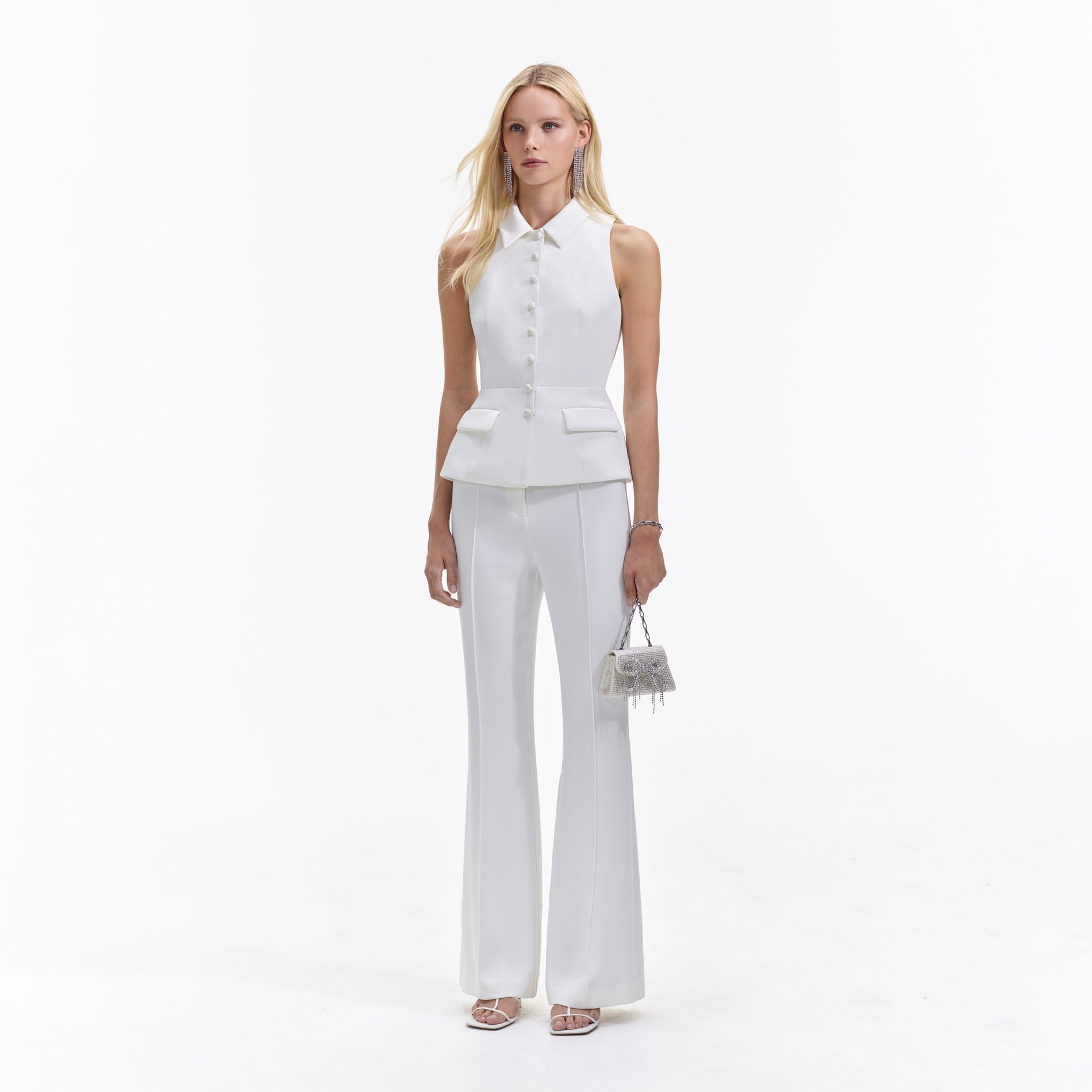 Side view of a woman wearing the Cream Tailored Jumpsuit