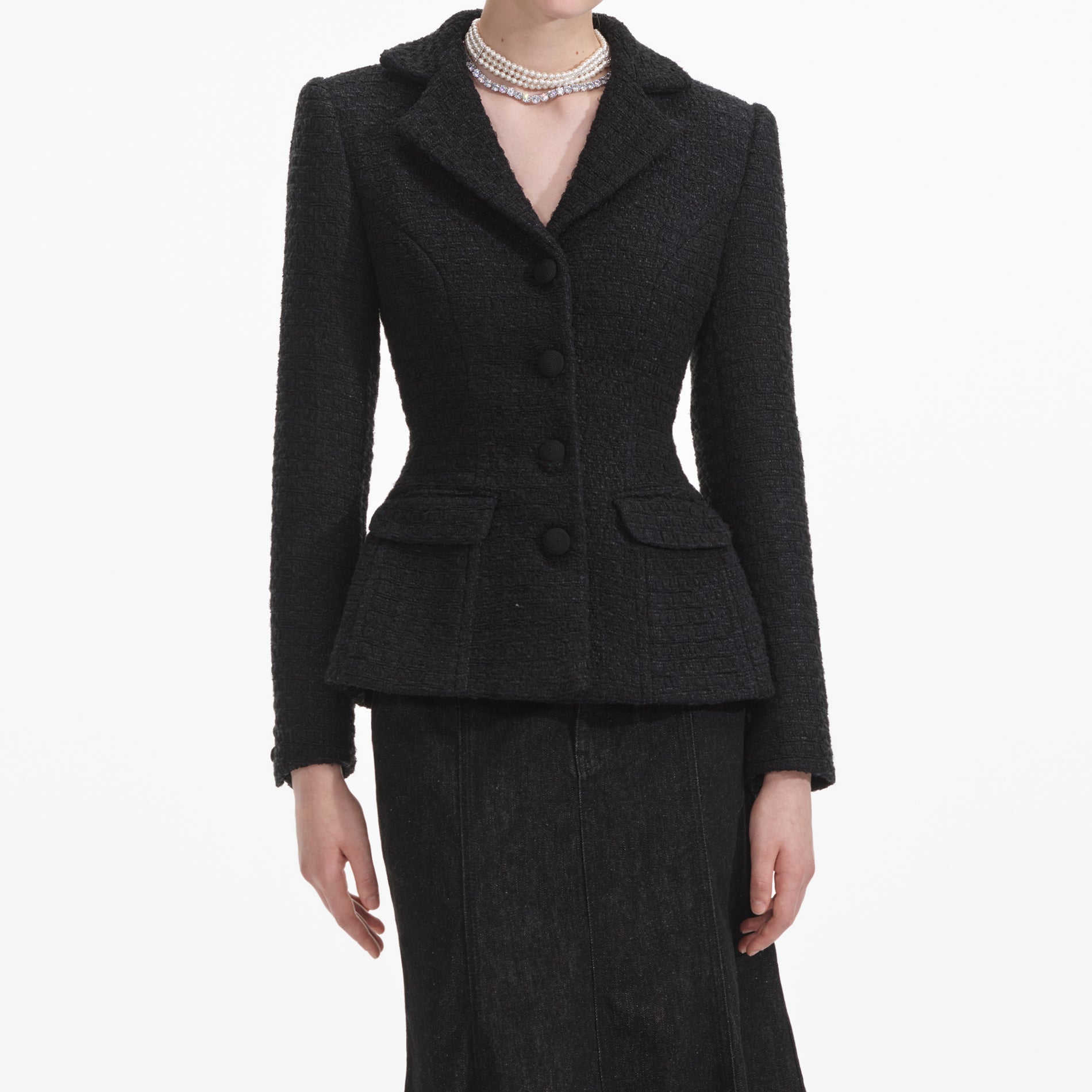 A close up of a woman wearing the Black Boucle Jacket