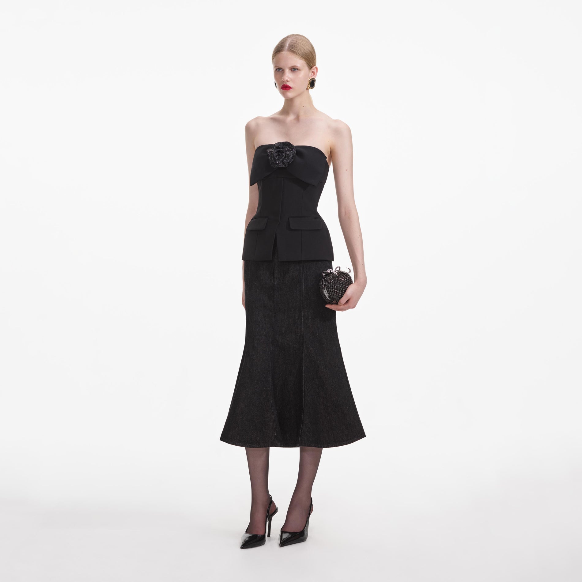 Side view of a woman wearing the Black Crepe Corsage Top