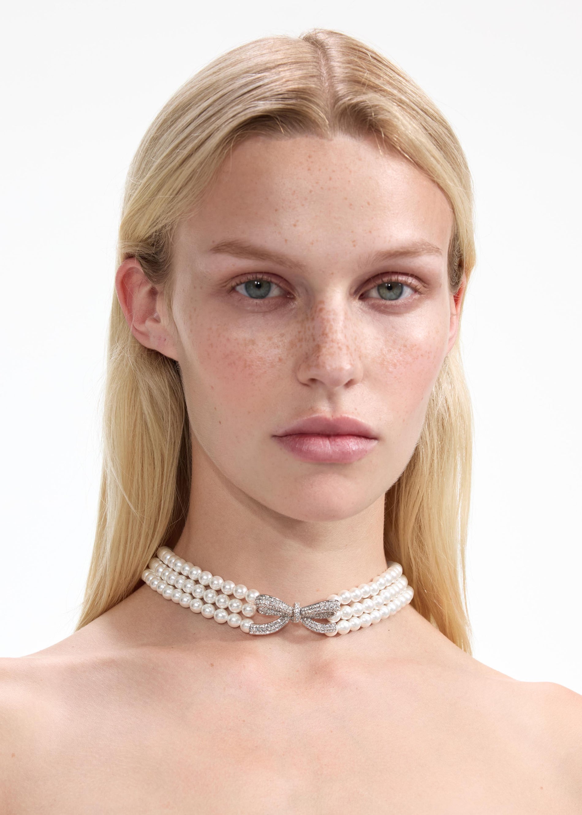 Front view of a woman wearing the Pearl Bow Choker