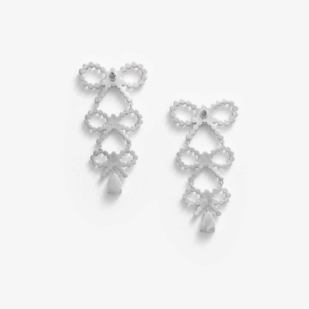 Side view of a woman wearing the Tiered Pearl Bow Earrings