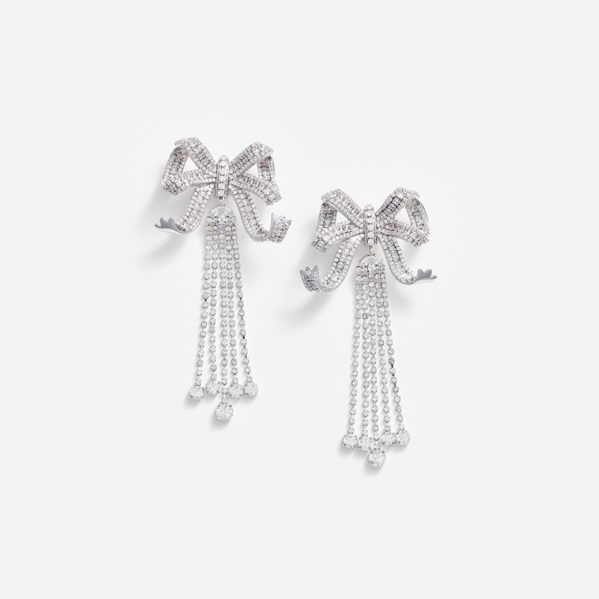 Front view of a woman wearing the Large Crystal Bow Droplet Earrings