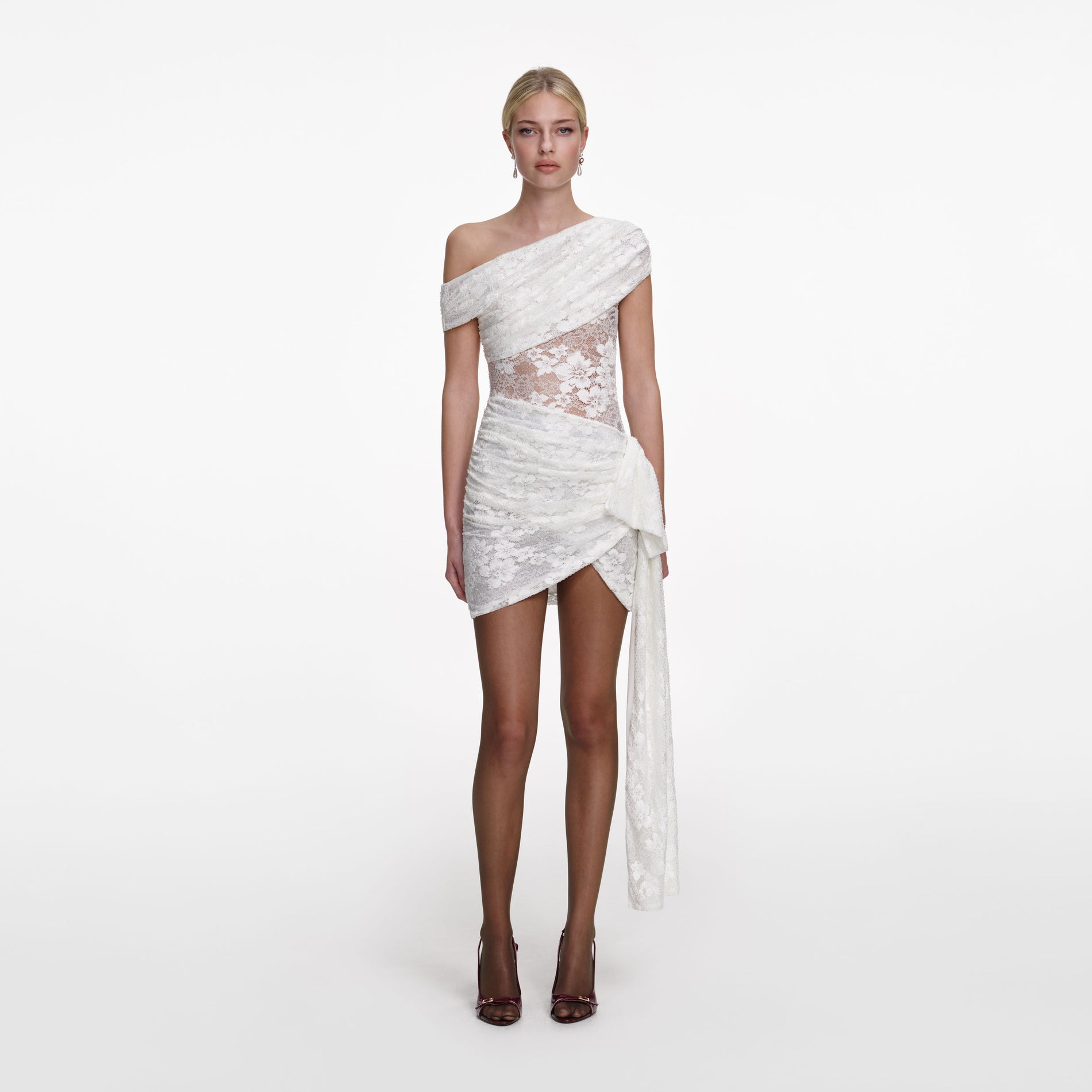 Front view of a woman wearing the White Rhinestone Lace Tie Side Mini Dress