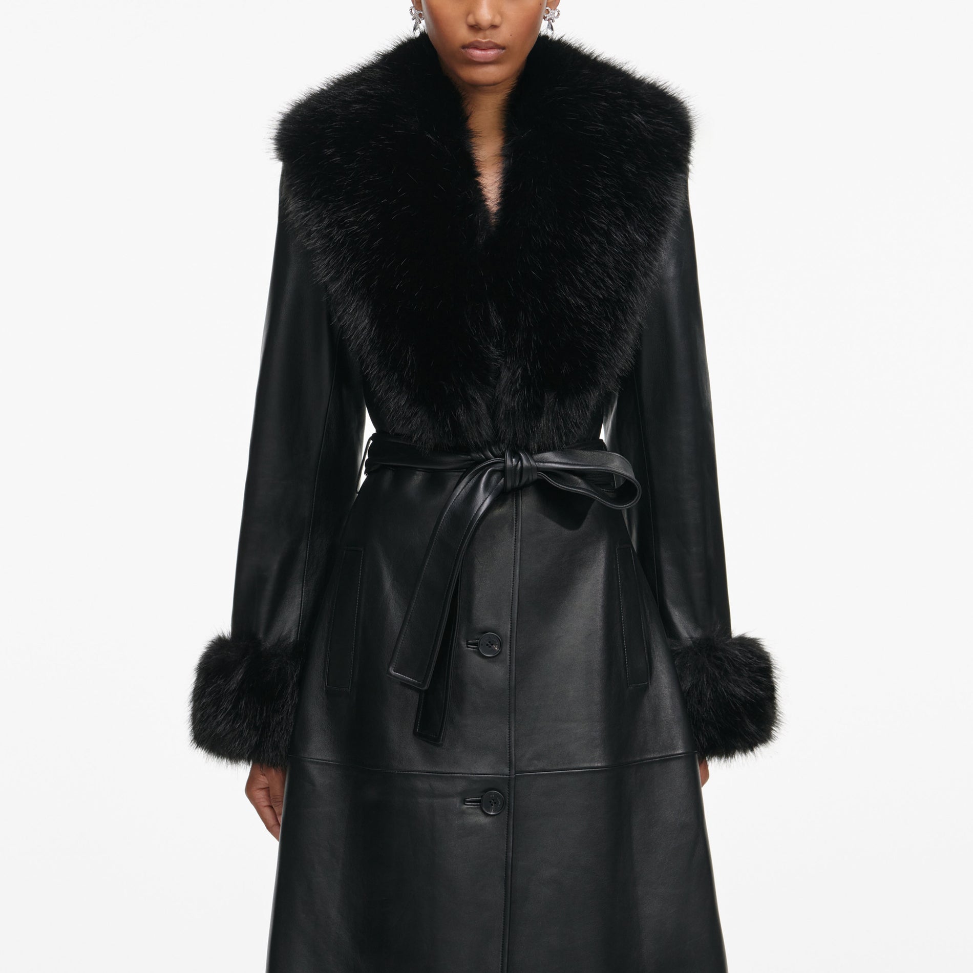 Side view of a woman wearing the Black Leather Faux Fur Collared Coat