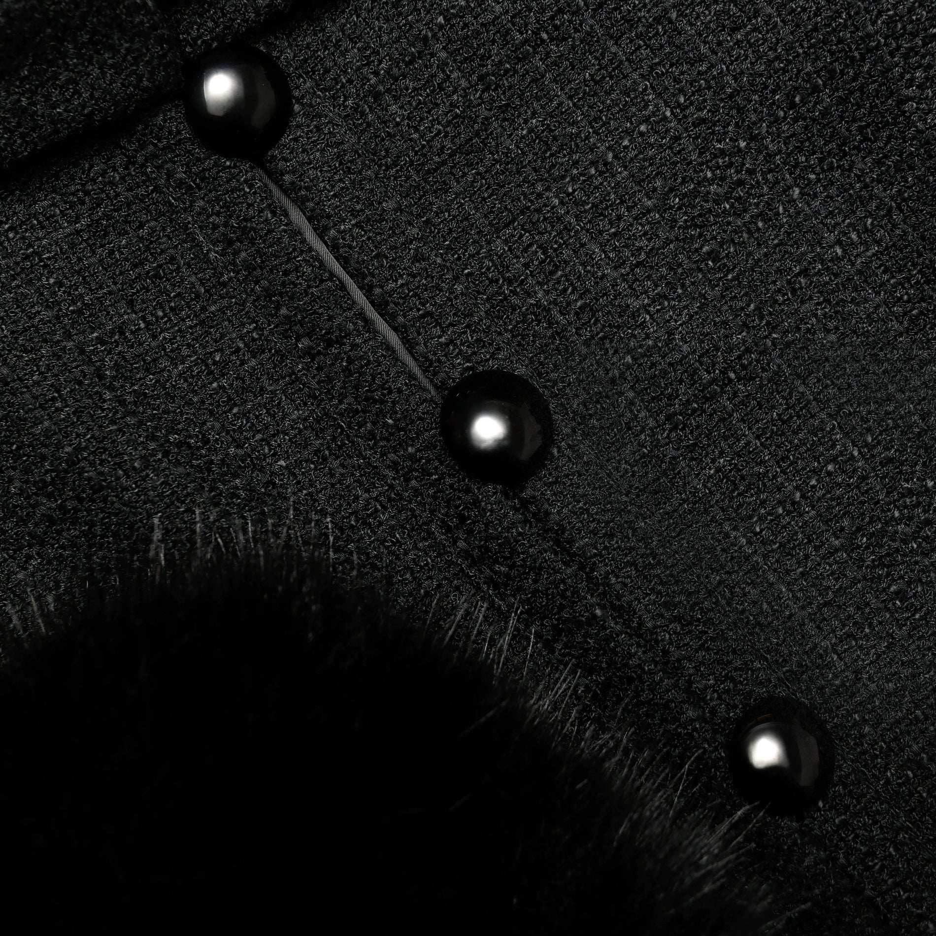 A close up of the fabric for the Black Boucle Faux Fur Cuff Jacket