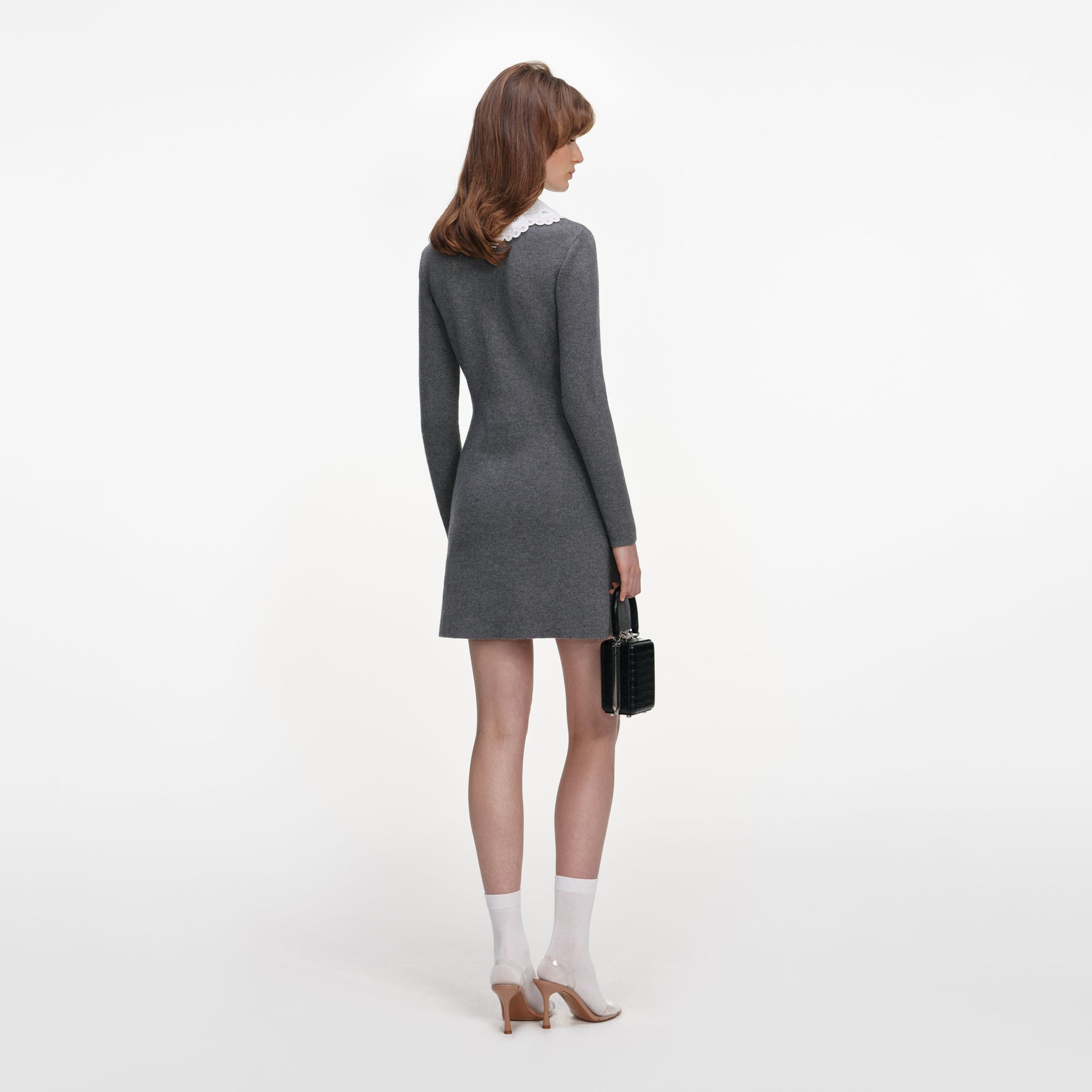 Back view of a woman wearing the Grey Knit Mini Dress