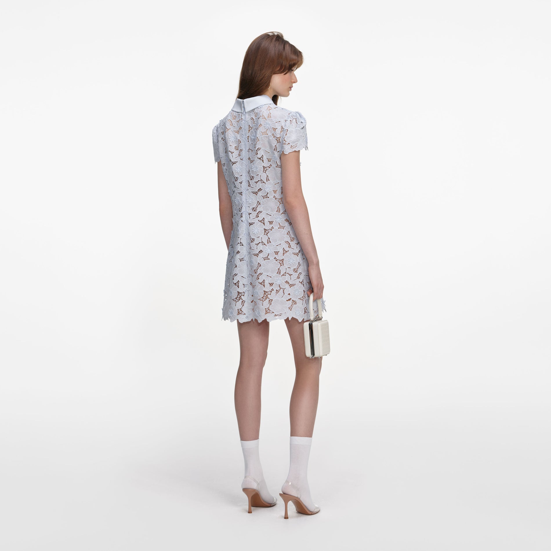 Back view of a woman wearing the Blue Guipure Lace Mini Dress