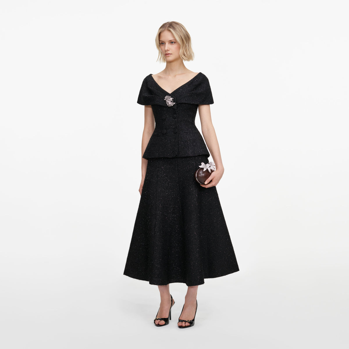 Side view of a woman wearing the Black Tinsel Boucle Brooch Midi Dress