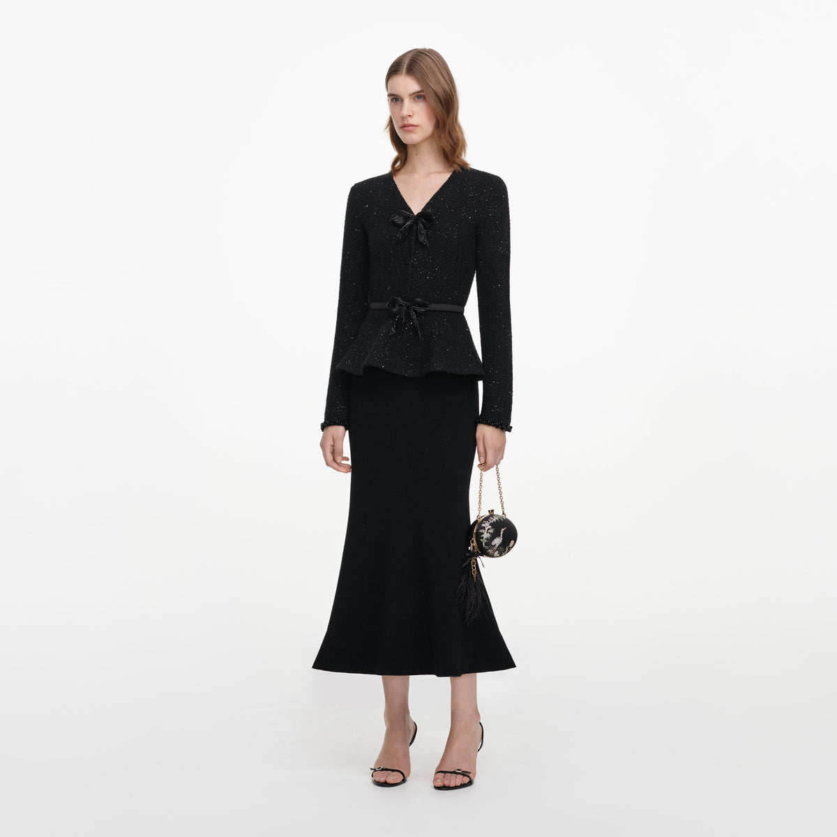 Side view of a woman wearing the Black Sequin Knit Midi Dress