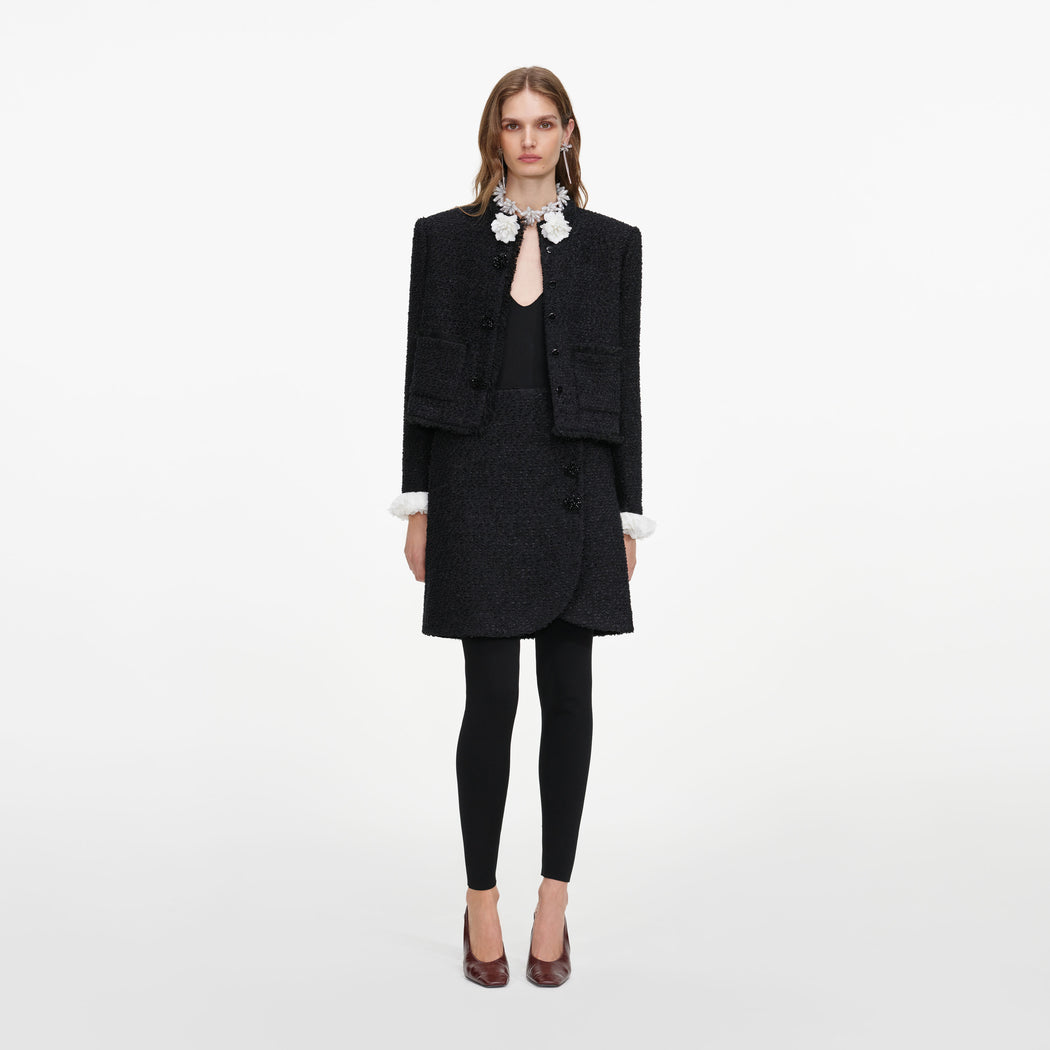 Front view of a woman wearing the Black Boucle Flower Jacket
