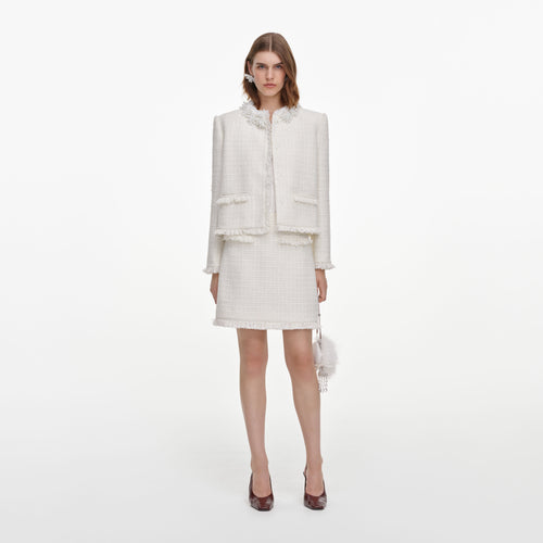 Front view of a woman wearing the Cream Sequin Boucle Mini Skirt