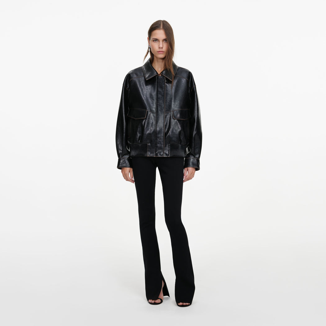 Front view of a woman wearing the Black Oversized Faux Leather Jacket