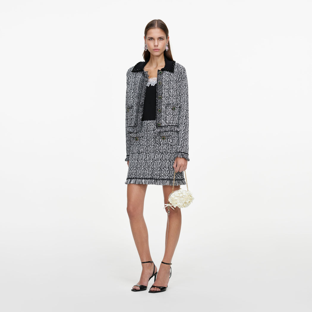 Side view of a woman wearing the Black And White Textured Knit Jacket