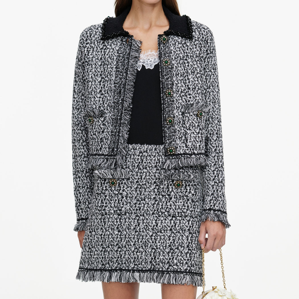 A close up of a woman wearing the Black And White Textured Knit Jacket