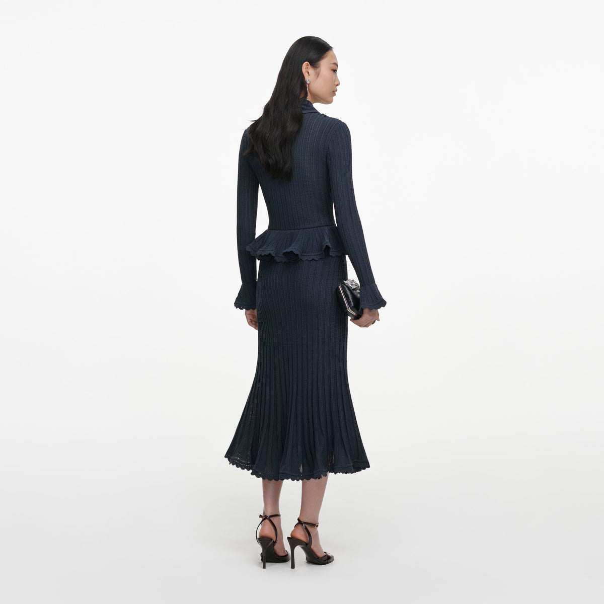 Back view of a woman wearing the Grey Peplum Pointelle Knit Midi Dress