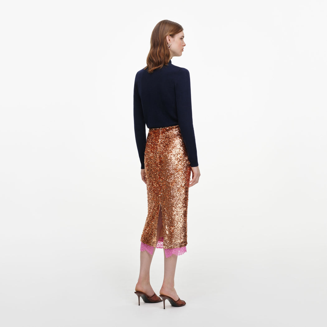 Back view of a woman wearing the Gold Sequin Midi Skirt